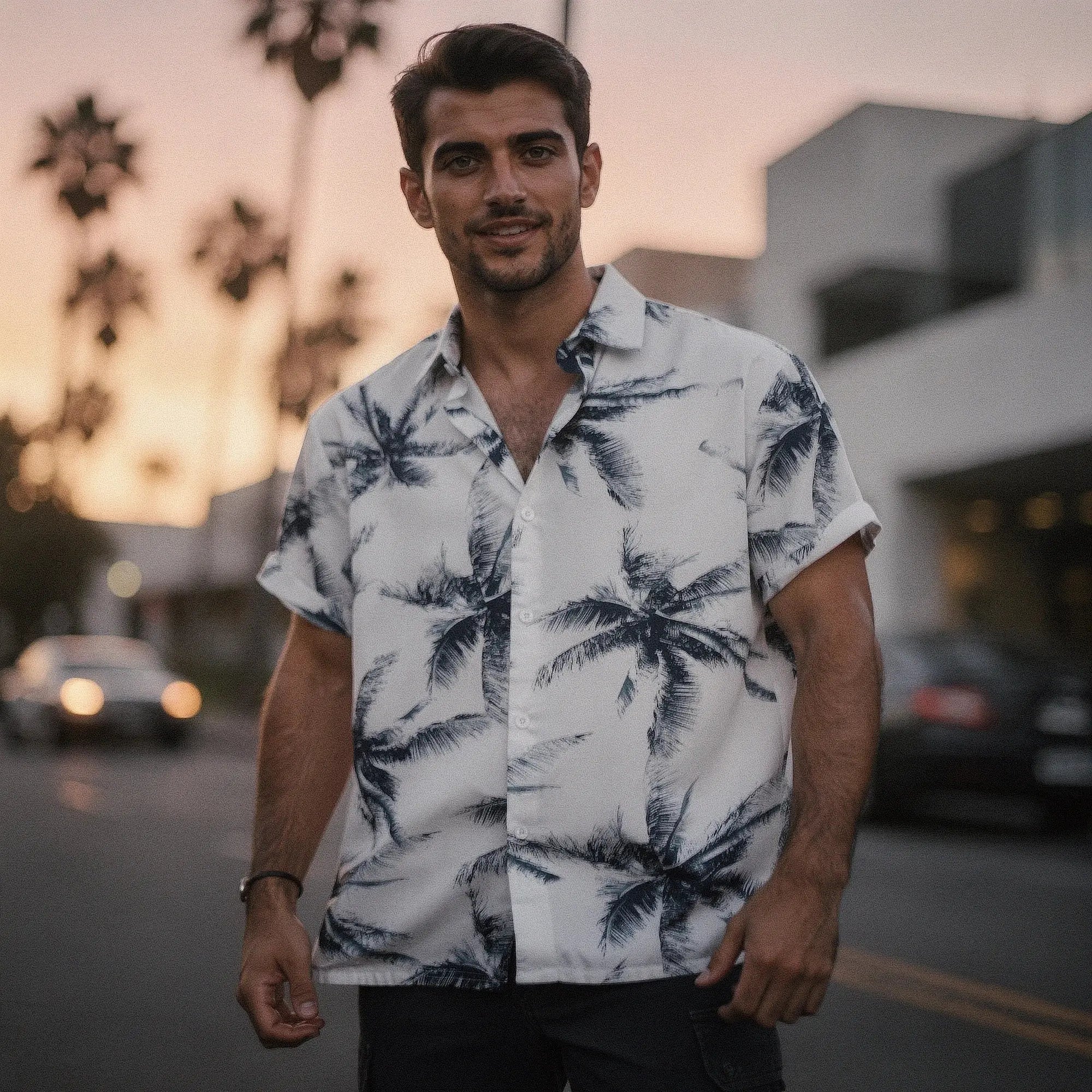 View of a slim fit short sleeve Hawaiian shirt featuring a vibrant floral pattern in shades of blue and green on a light background