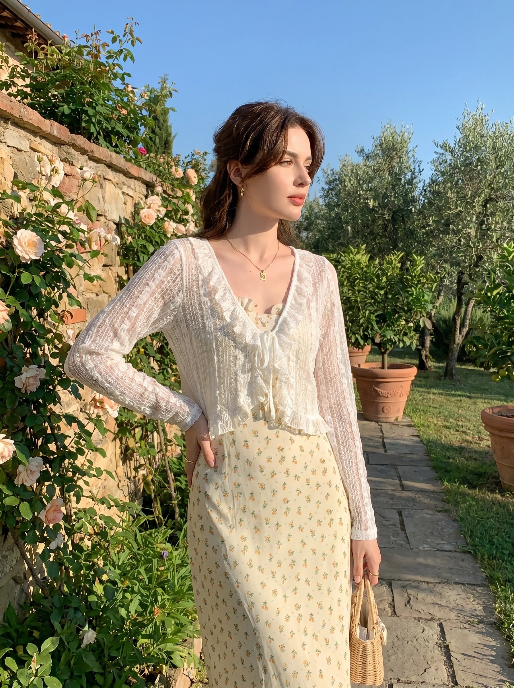 Close up view of the Womens Delicate Ruffled Summer Blouse showing intricate stitching and soft fabric texture, showing its playful ruffled details against a neutral background.