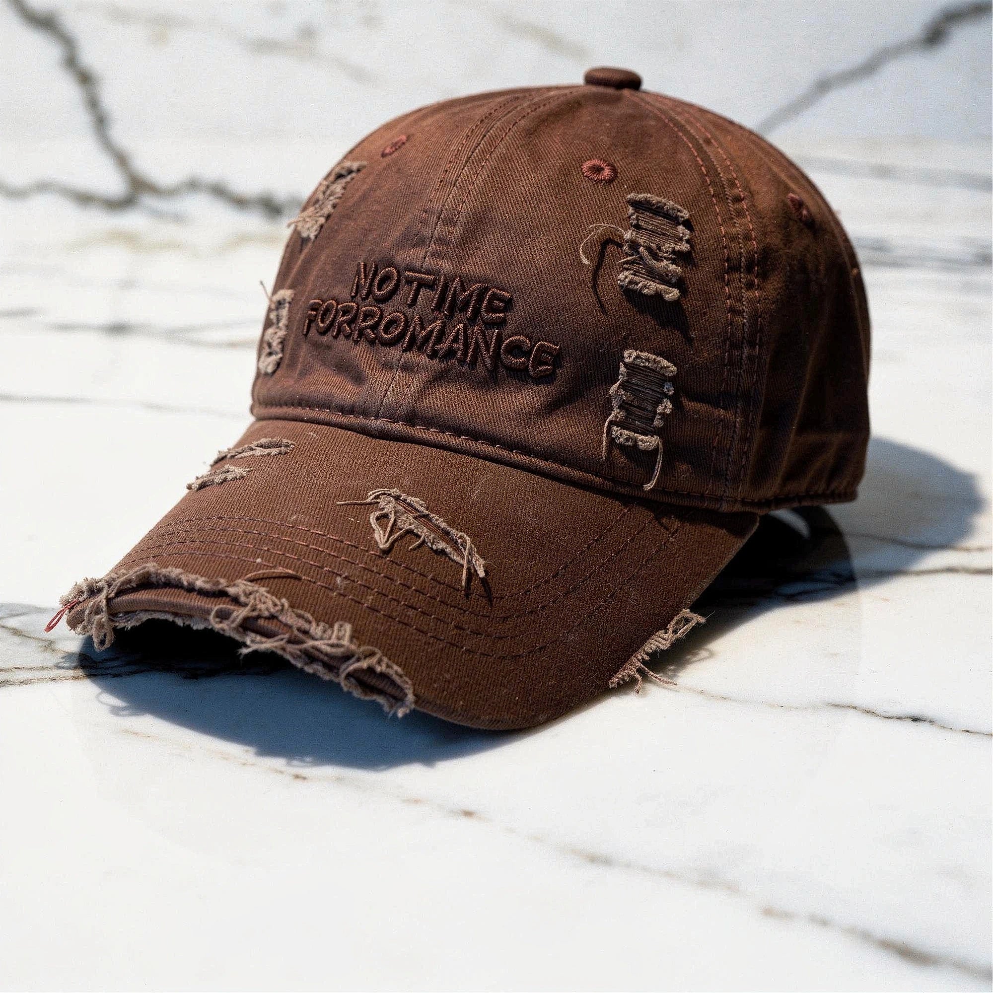Light gray distressed baseball cap with a curved brim and adjustable strap, detailed view showcasing fabric texture
