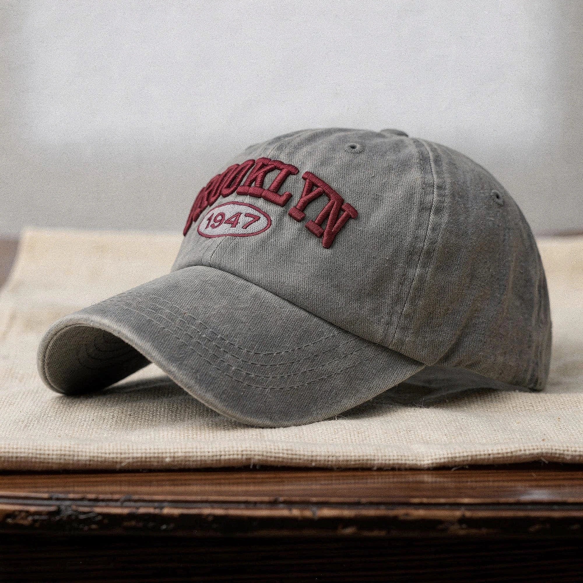 View of a navy blue embroidered cap with a casual chic design, featuring a curved brim and adjustable strap