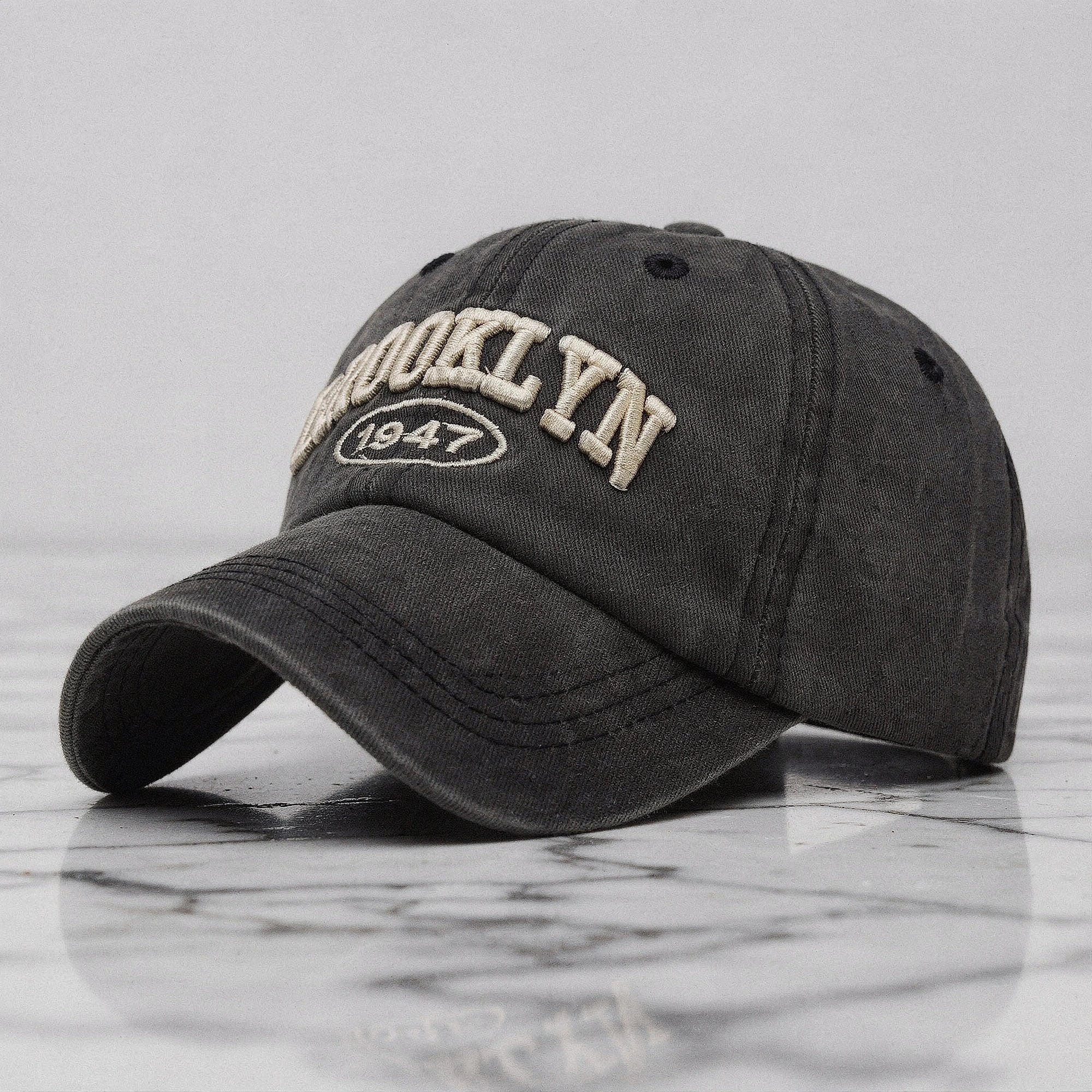 View of a casual chic embroidered cap in navy blue, featuring intricate stitching and a relaxed fit