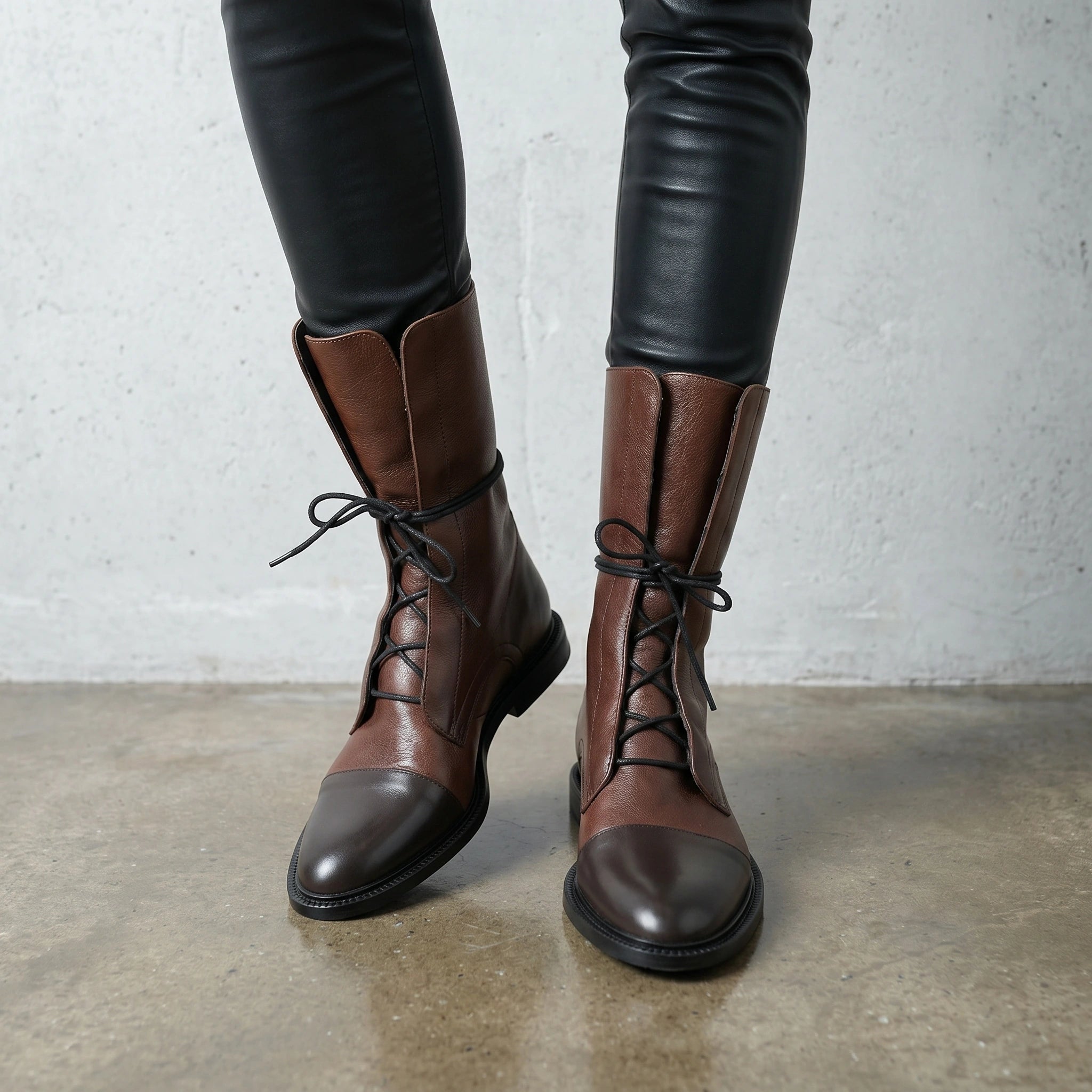 Close up view of the Womens Edgy Minimalist Ankle Boots showing the sleek black leather texture and precise stitching details for a refined, modern look.