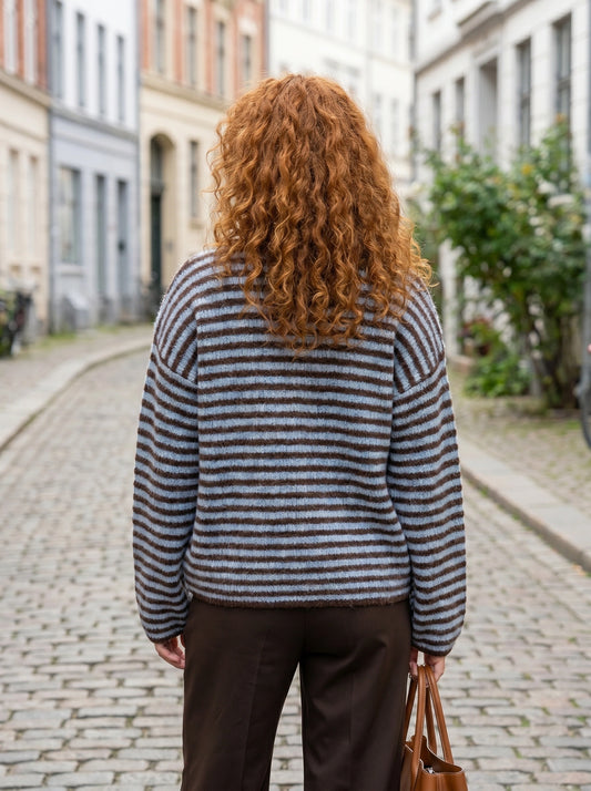 Close up of the Womens Relaxed Striped Autumn Cardigan showing the soft fabric texture and intricate stitching in warm autumn hues.
