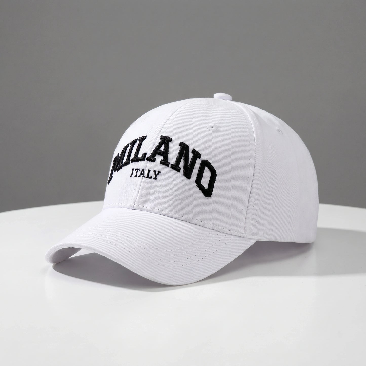 Close up view of the embroidered design and durable fabric of the adjustable baseball cap, showing its quality craftsmanship against a neutral background.