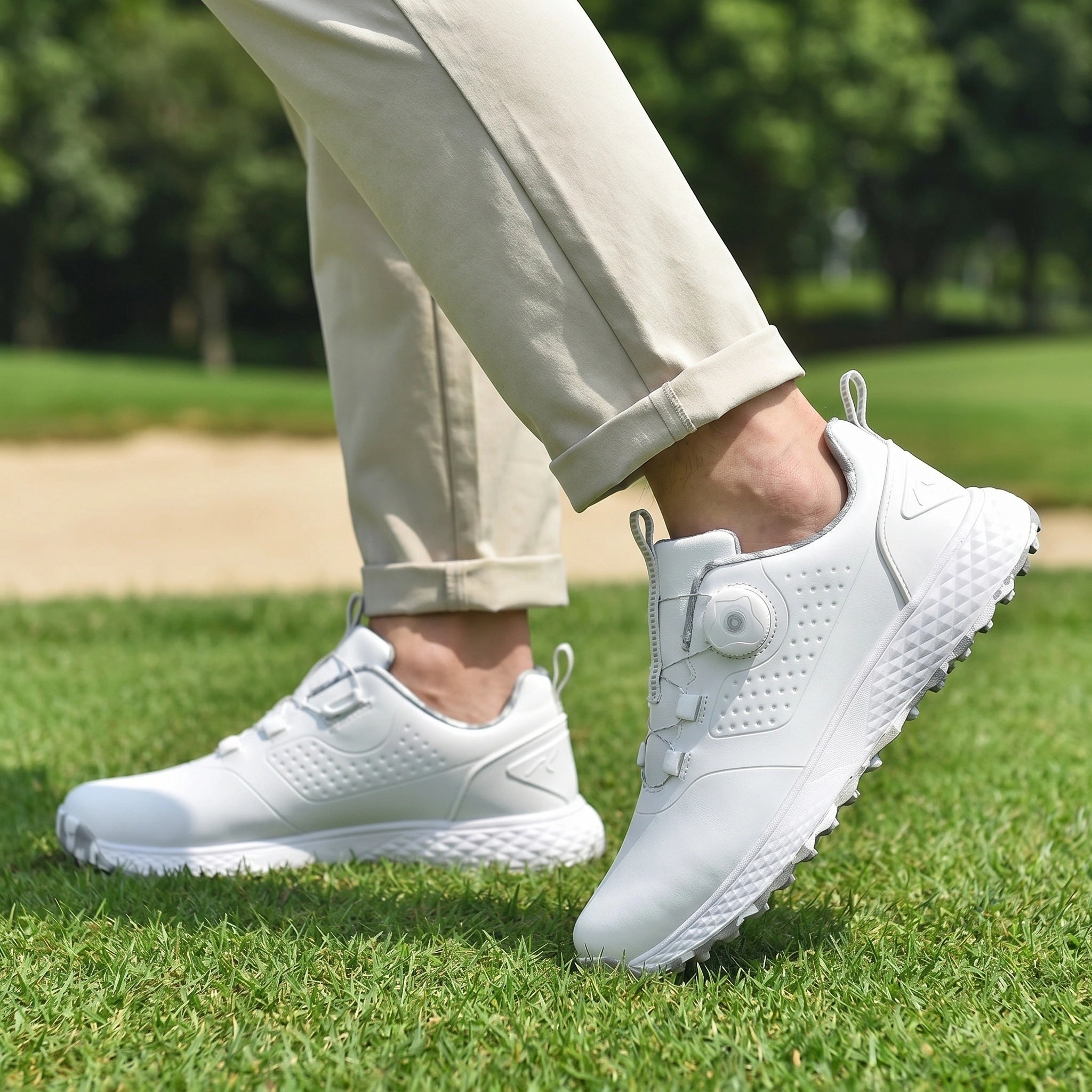 Back view of men's waterproof casual golf sneakers showing the sleek design, durable construction, and comfortable fit against a neutral outdoor background.