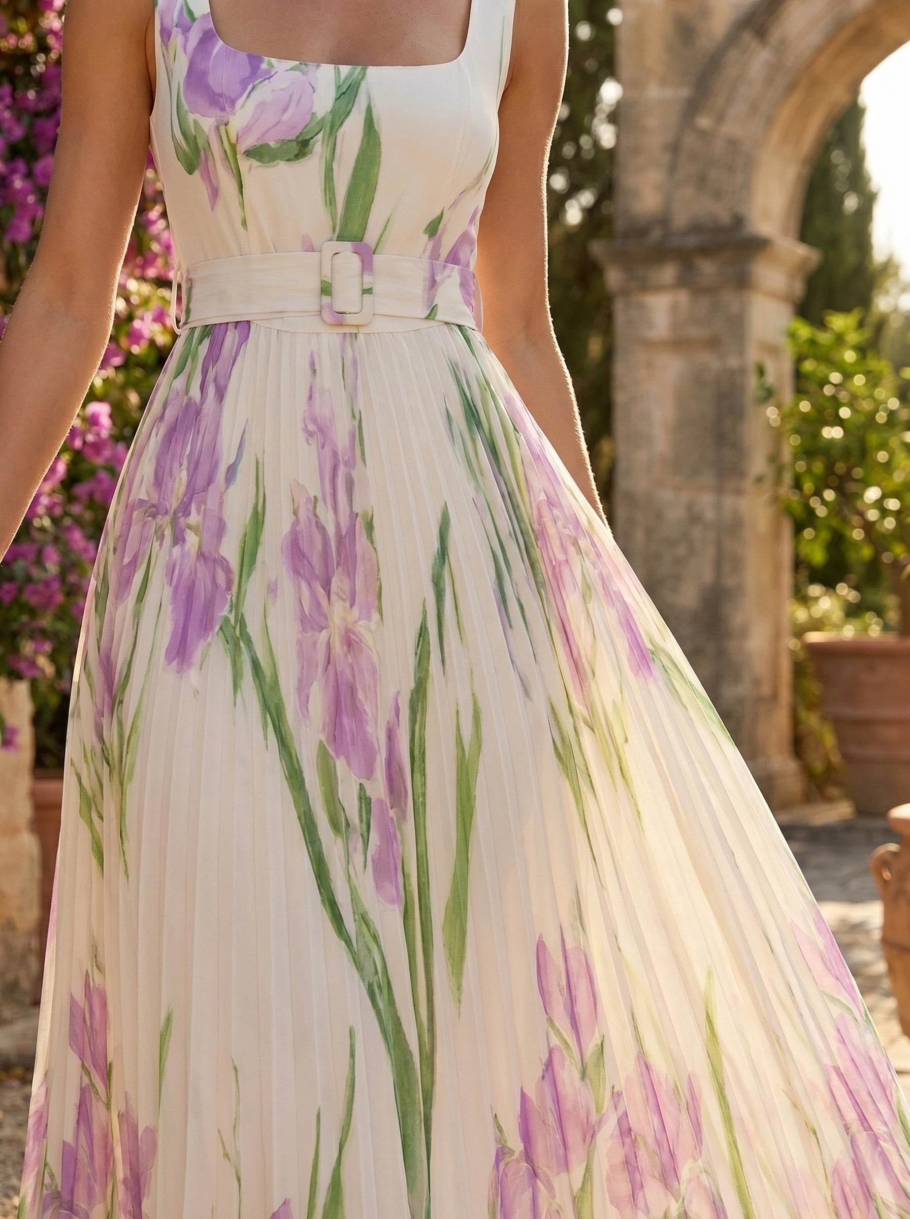 A model showcases a flowy summer maxi dress in a soft pastel hue, styled with minimal accessories against a bright outdoor background.
