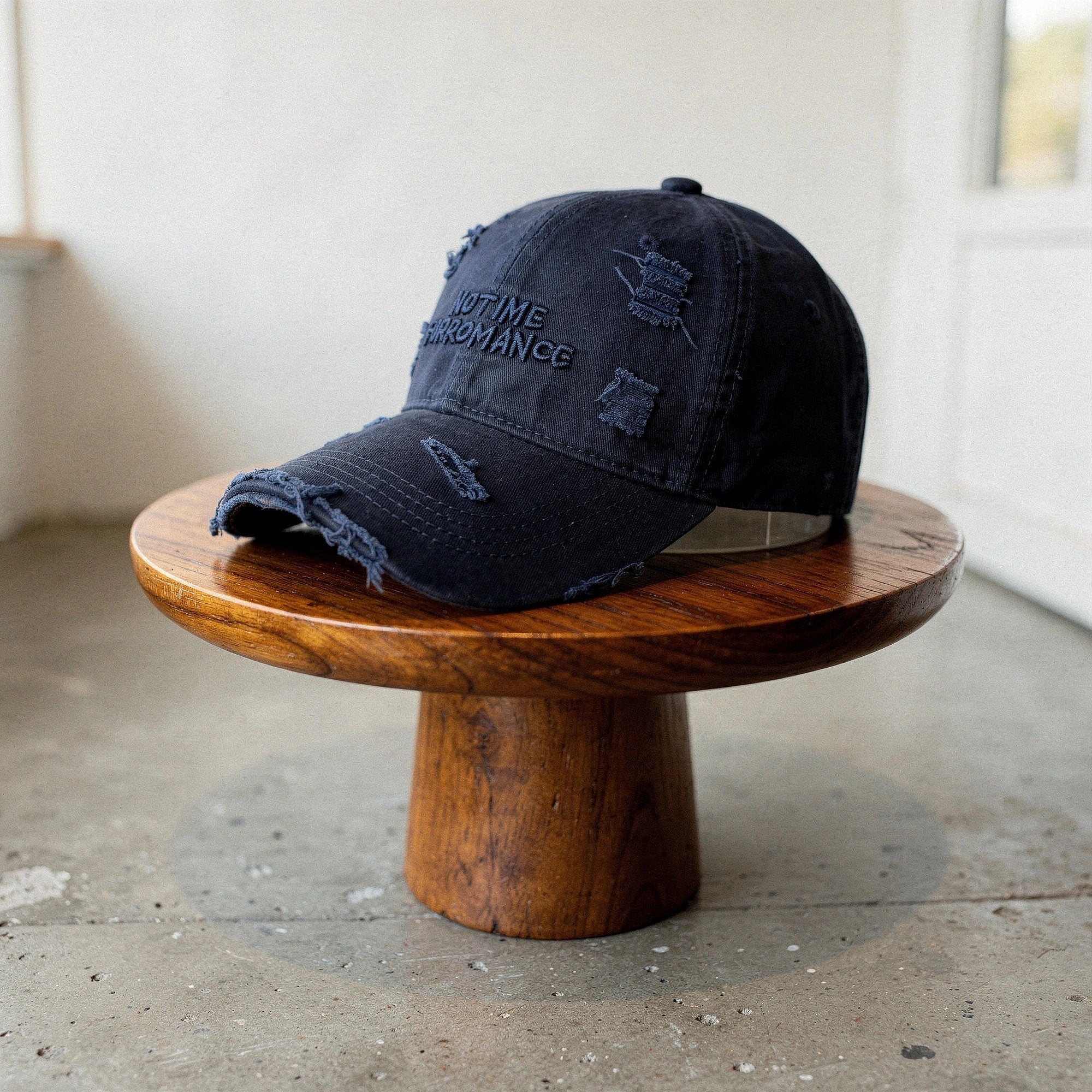 Distressed light blue baseball cap with a curved brim and adjustable strap, detailed view showcasing fabric texture and stitching