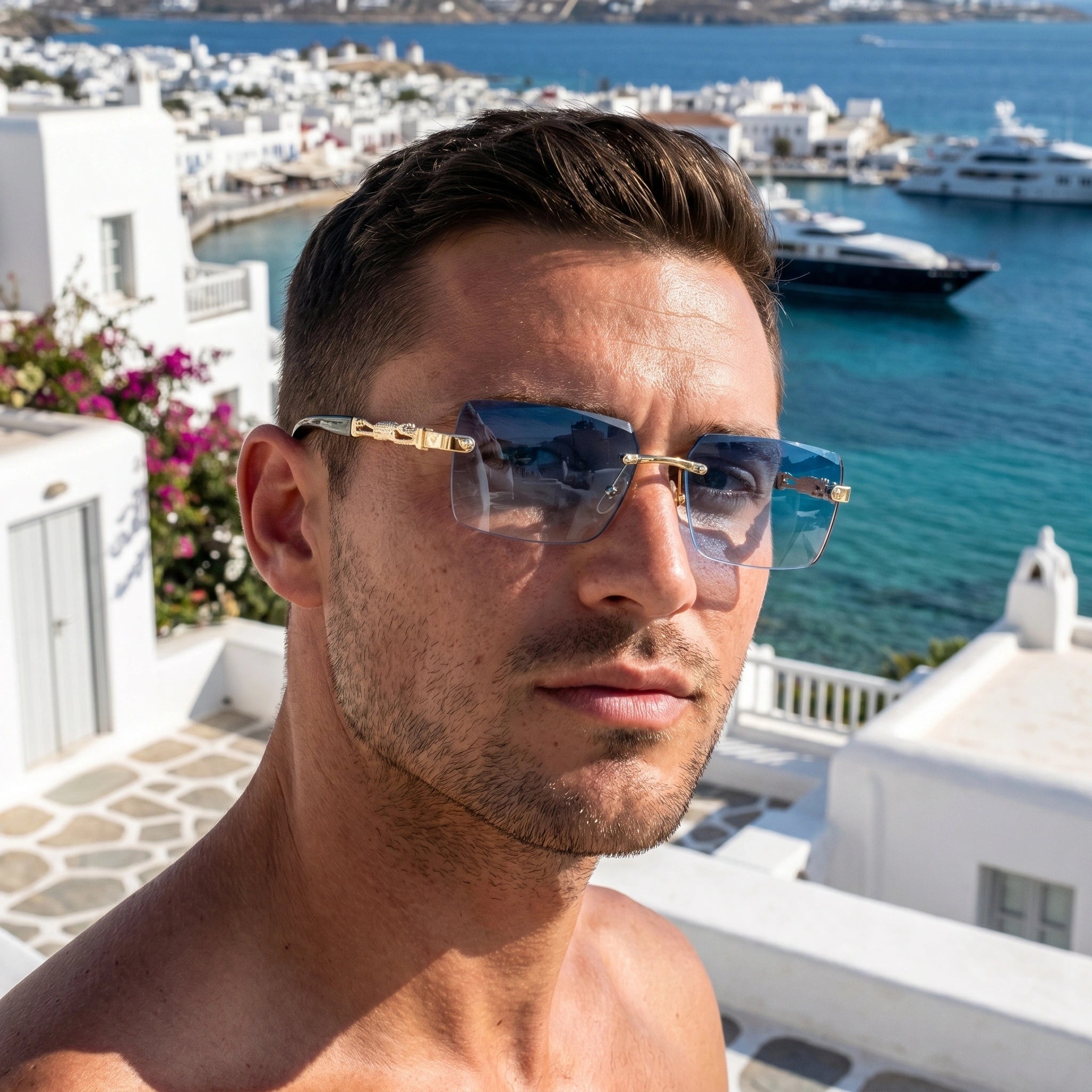 Front view of a model showing mens sleek summer sunglasses, paired with a light linen shirt and tailored shorts against a bright outdoor background.