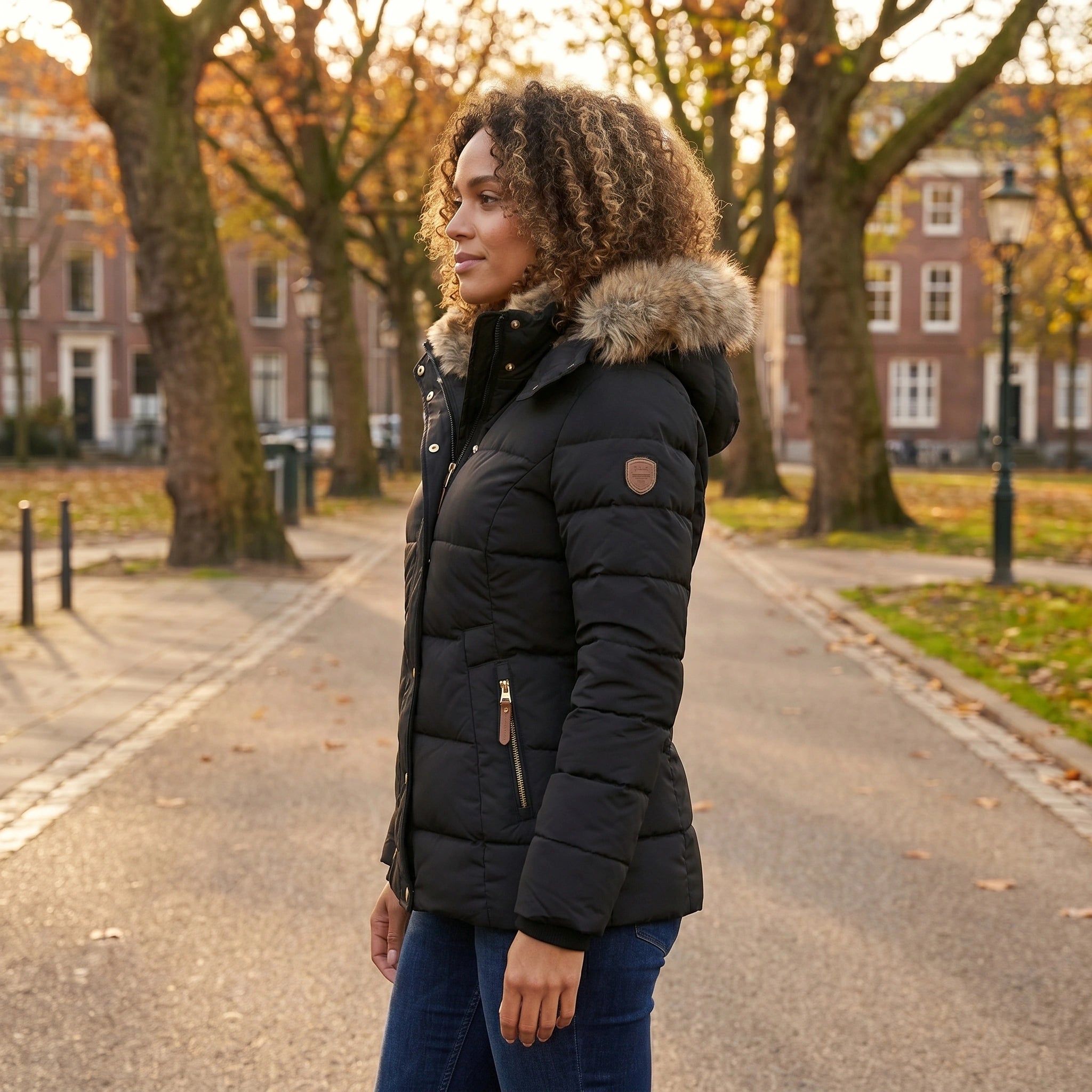 Close up of the Womens Fitted Winter Puffer Jacket showing the high quality fabric, intricate stitching, and sleek silhouette against a soft neutral background.