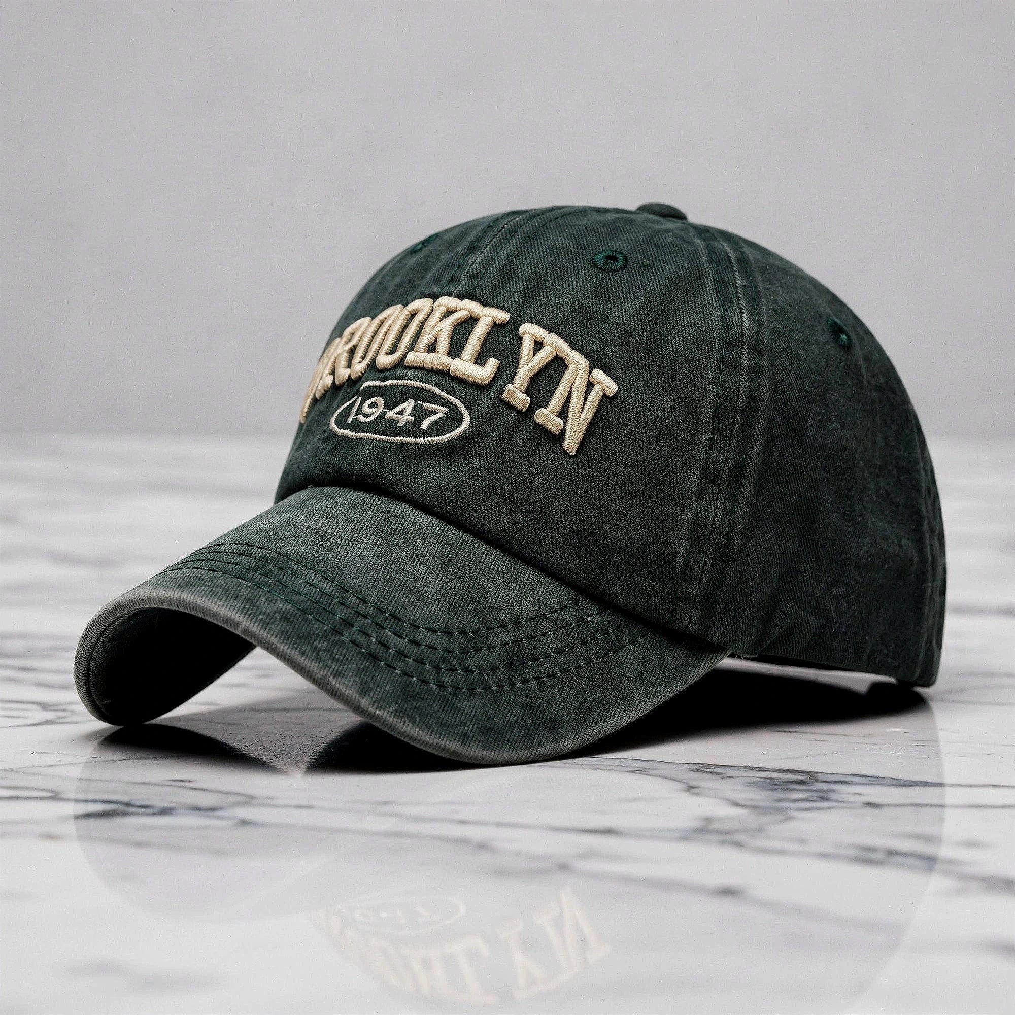 View of a casual chic embroidered cap in light gray, featuring intricate stitching and a curved brim