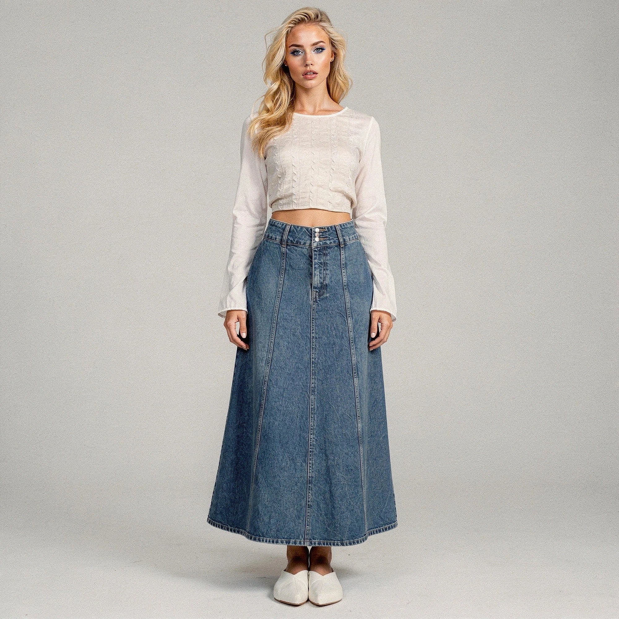 View of a flowy midi skirt in soft beige fabric, featuring a flattering high waist and subtle pleats