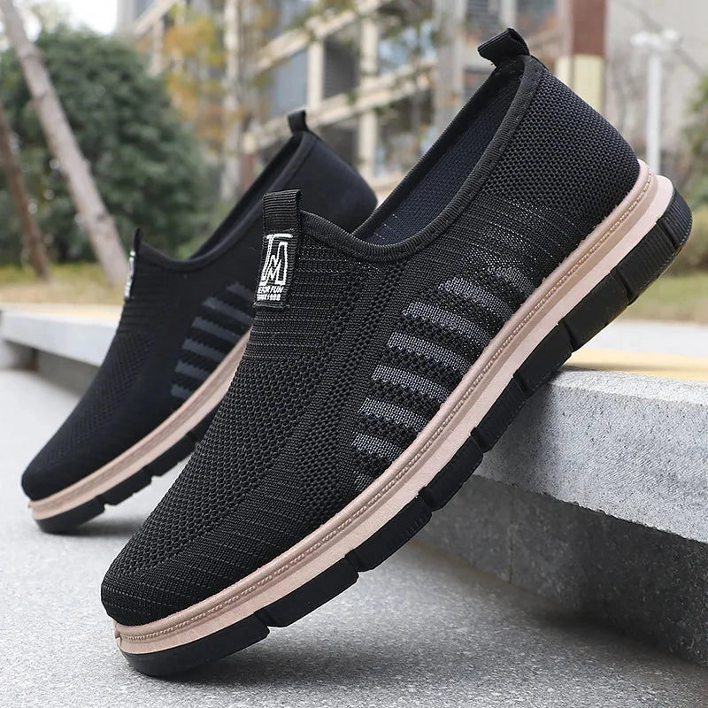 View of stylish men's casual shoes featuring a knit upper in a light gray color with a textured finish