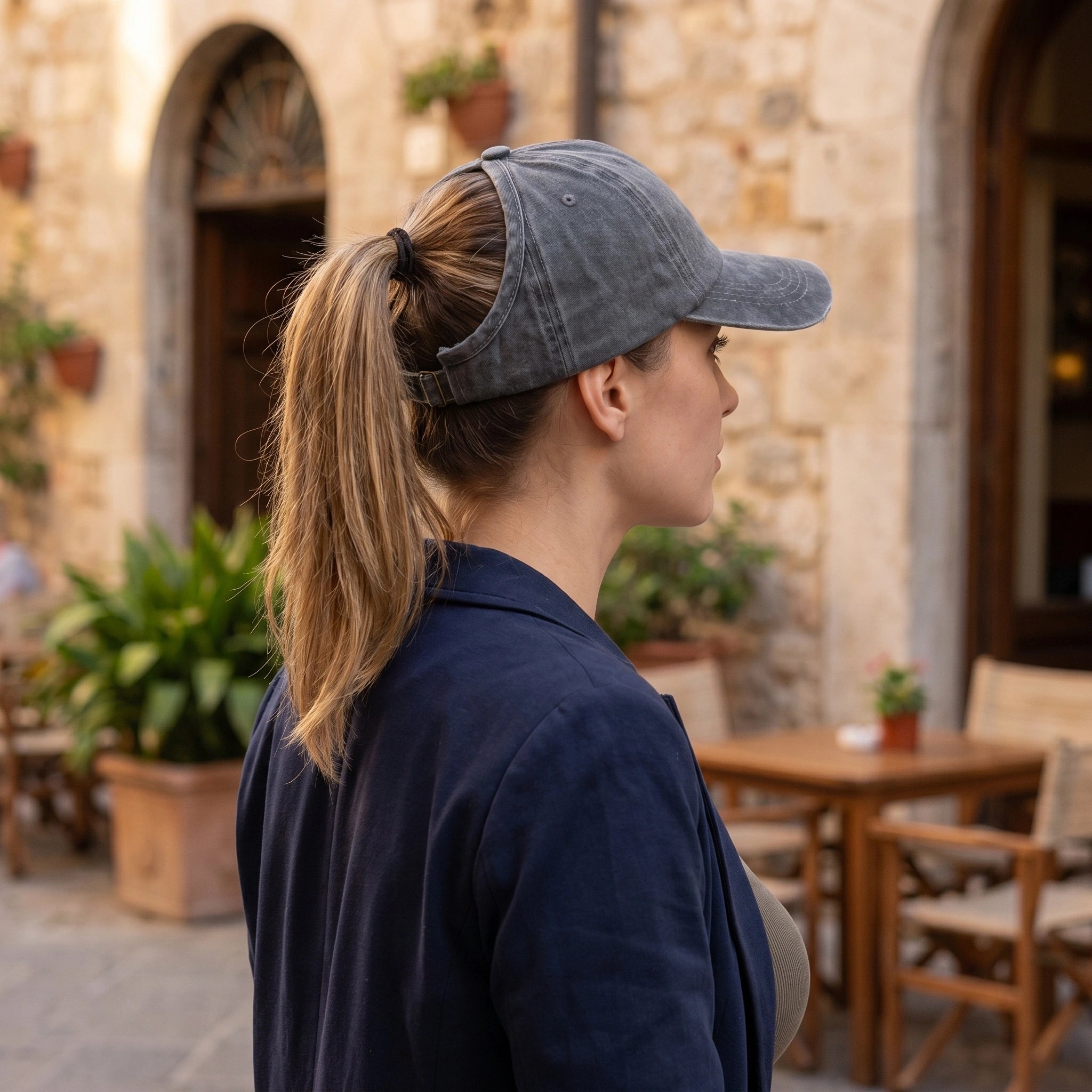 Close up view of the washed cotton fabric and detailed stitching of a backless baseball cap, showing its quality and outdoor versatility.