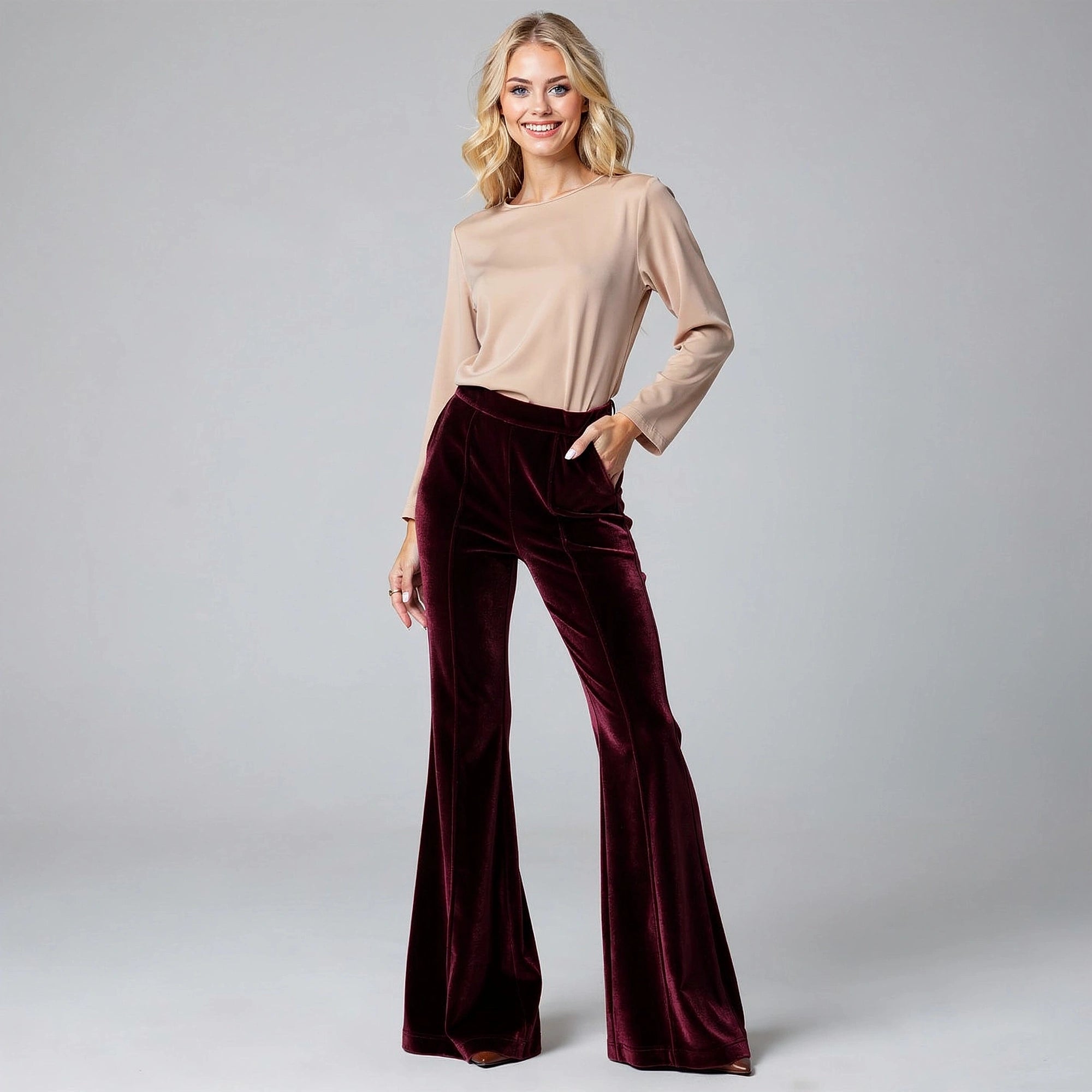 View of luxurious flared trousers in soft fabric, featuring a rich burgundy color and a flattering high waist