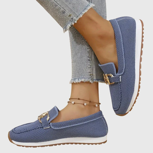 View of elegant women's loafers in soft beige leather, featuring a breathable design and a comfortable flat sole