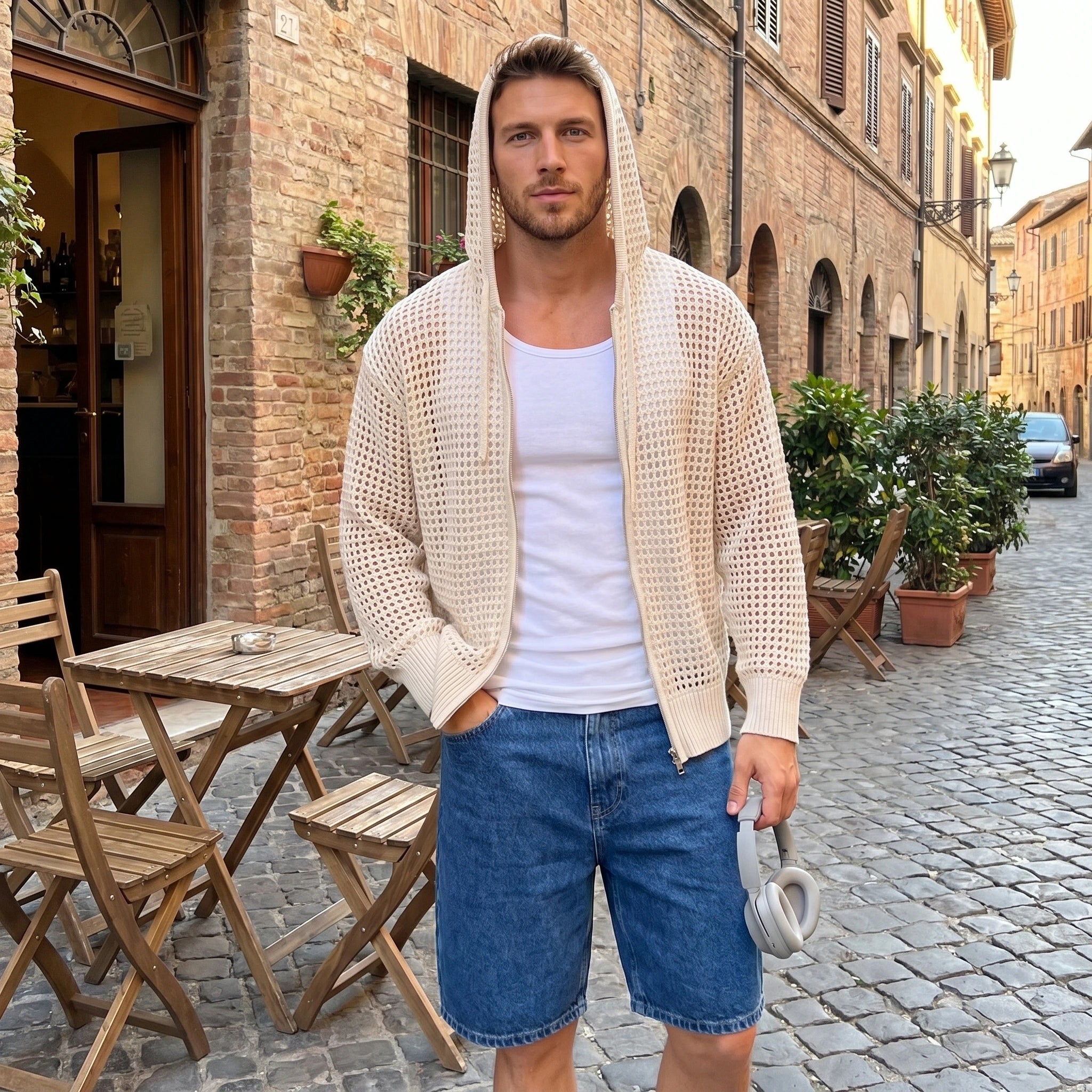 Back view of a model wearing a navy blue mens casual lightweight summer hoodie, showing its sleek construction and design against a minimalist backdrop.