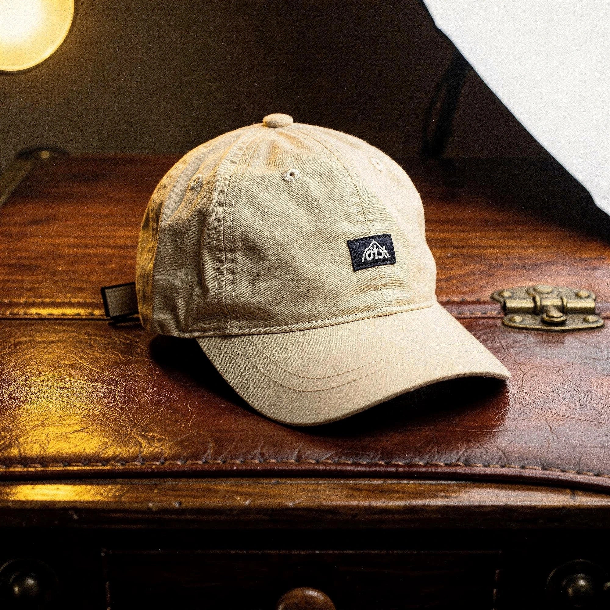 View of a stylish men's baseball cap in dark gray, made from breathable fabric, featuring a curved brim and adjustable strap