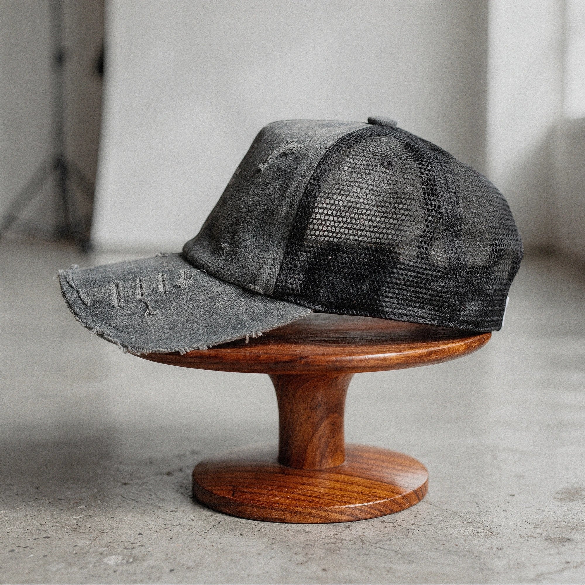 Light pink summer baseball cap made of breathable fabric, featuring a curved brim and adjustable strap, detailed view
