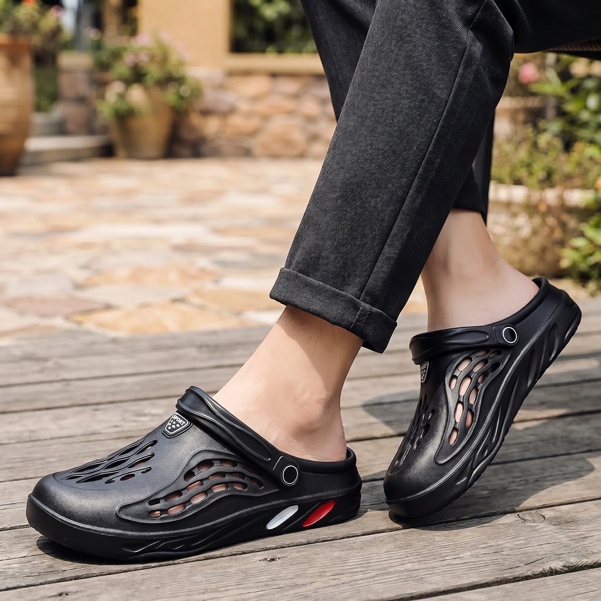 A model showcases men's relaxed versatile summer sandals in a outfit showing neutral tones, set against a bright outdoor background.