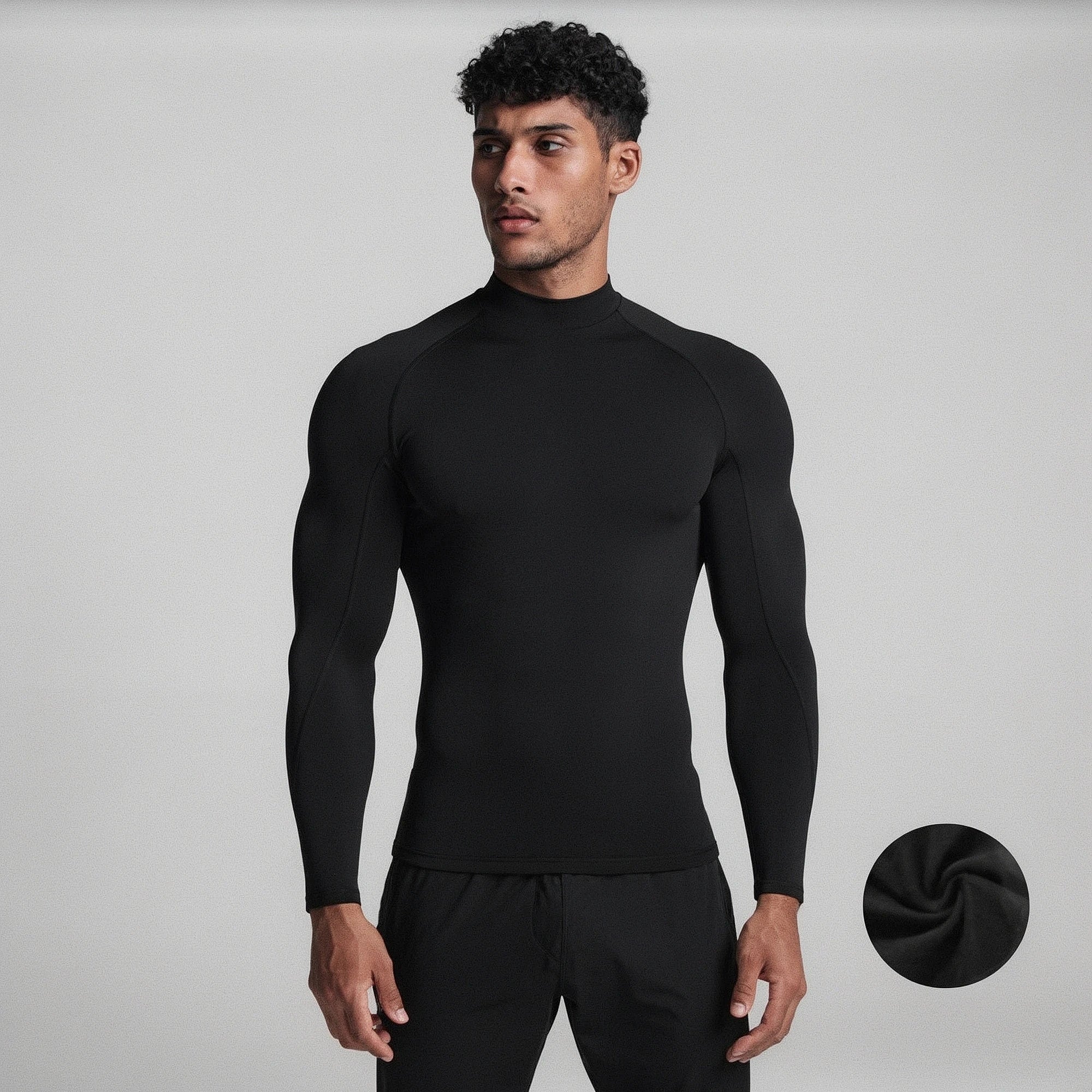 View of a black fleece backed compression winter tee with long sleeves and a fitted design