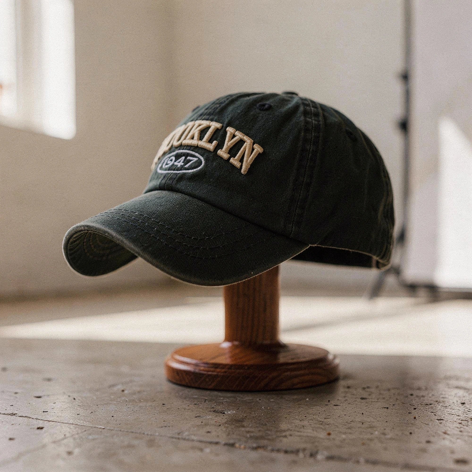 View of a navy blue embroidered cap made from cotton, featuring a stylish casual design and a curved brim