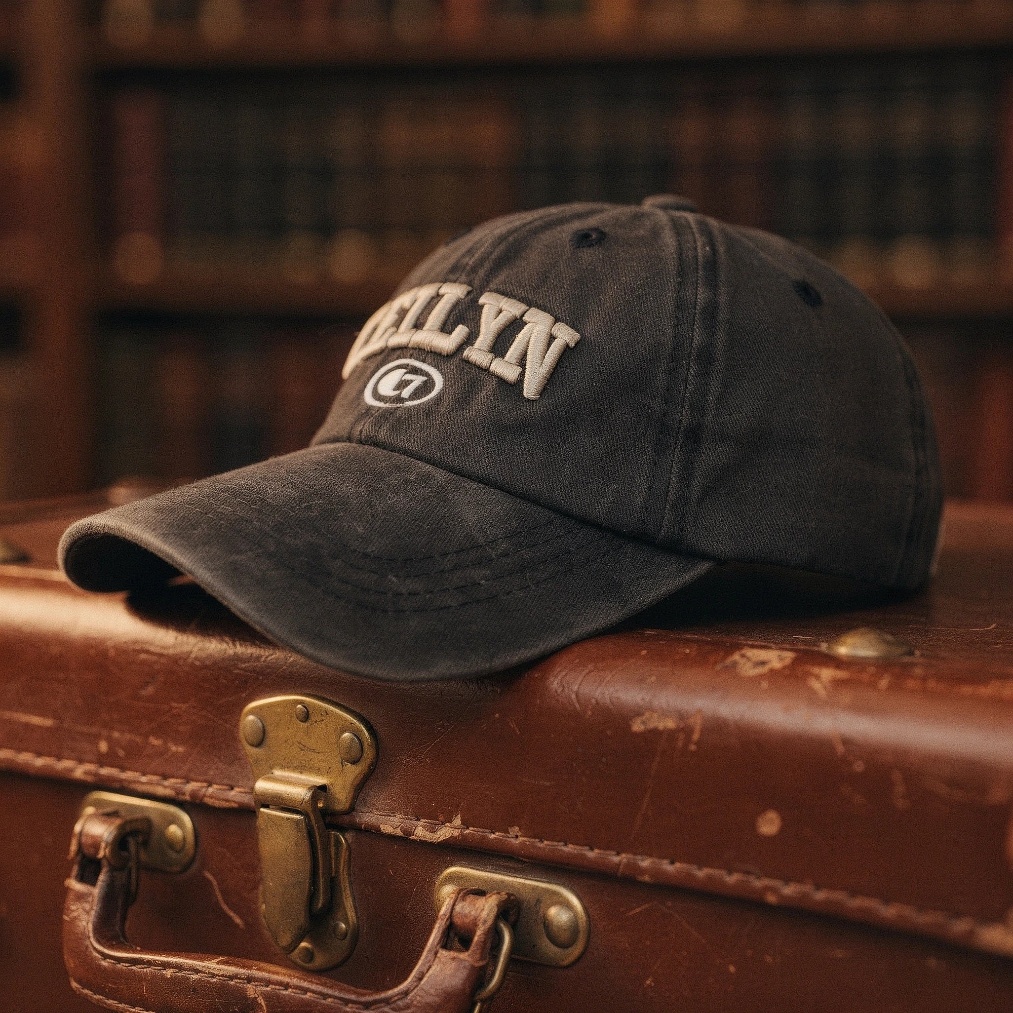 View of a navy blue embroidered cap featuring a casual chic design and adjustable strap at the