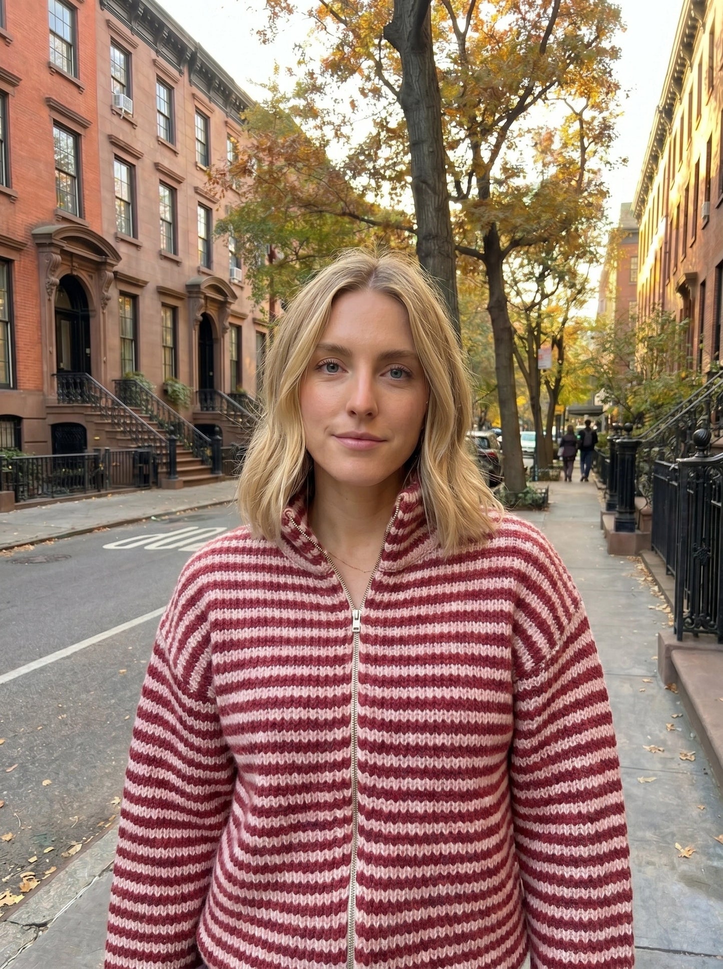 Close up view of the Womens Relaxed Striped Autumn Cardigan showing the soft fabric texture and precise stitching details in warm autumn hues.