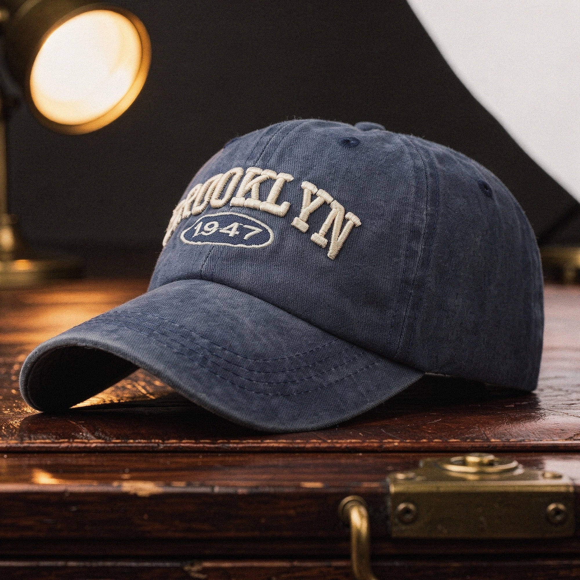 View of a navy blue embroidered cap featuring a casual chic design and adjustable strap