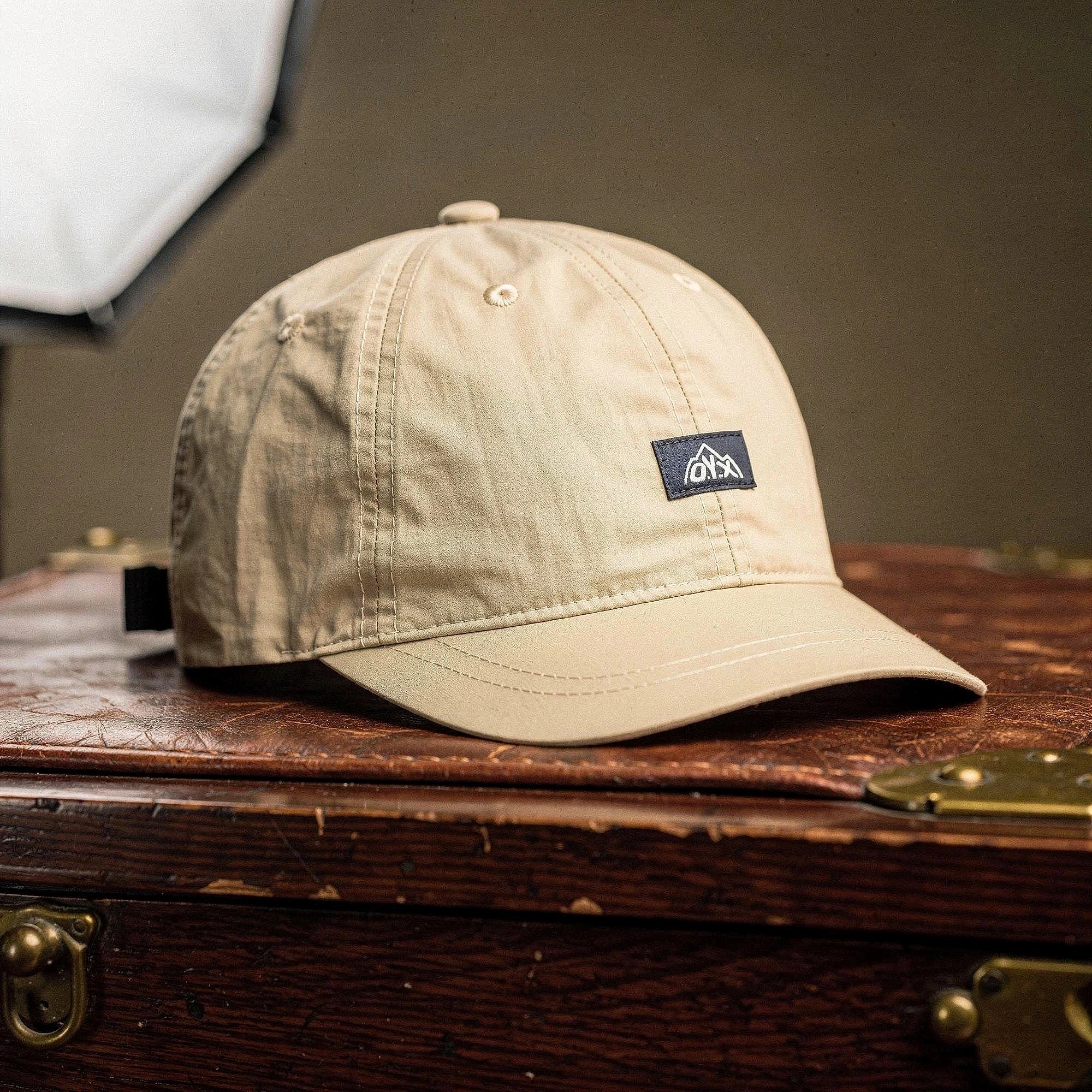 View of a stylish black baseball cap made of breathable fabric, featuring a curved brim and adjustable strap