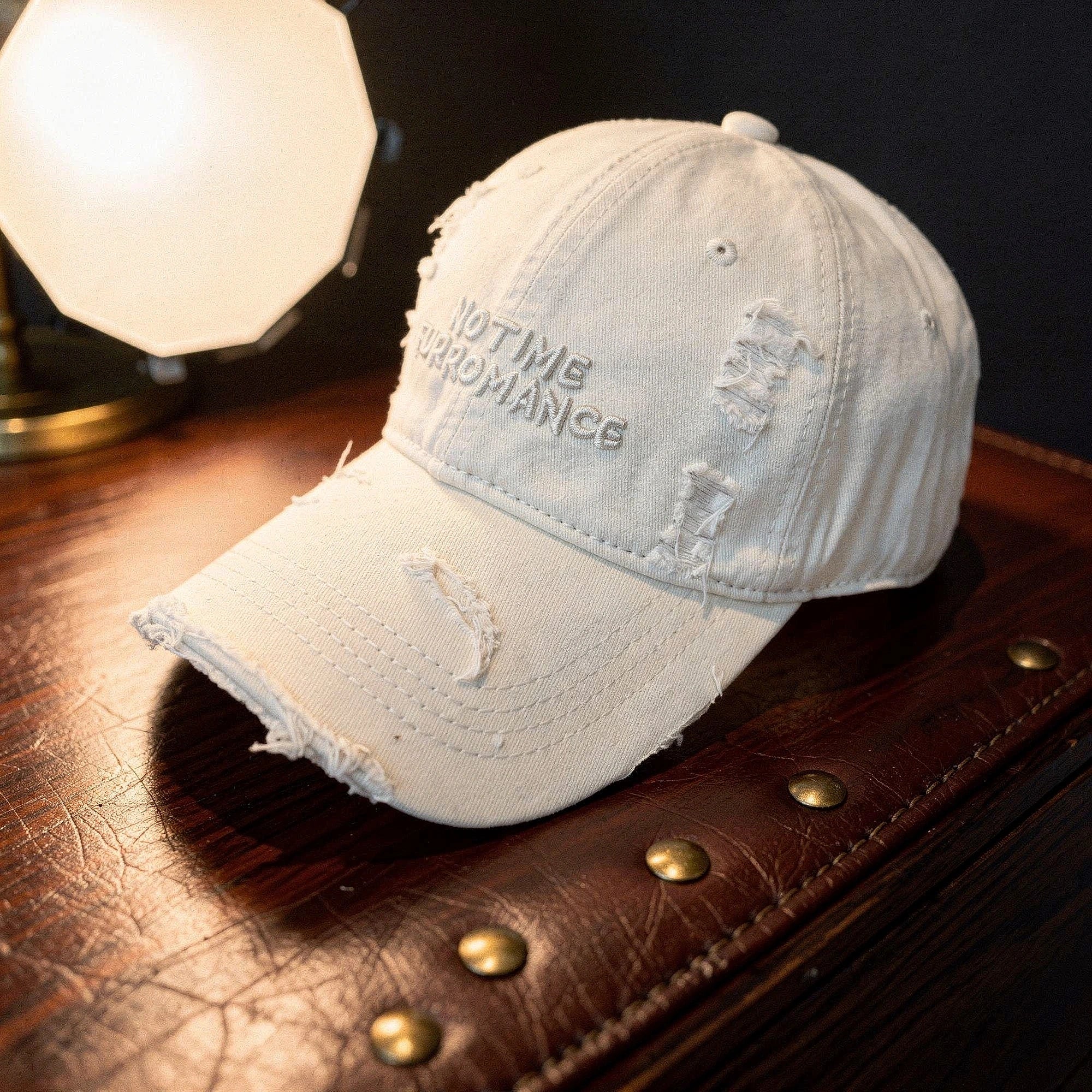 Light blue distressed baseball cap with a curved brim and adjustable strap, detailed view showcasing fabric texture