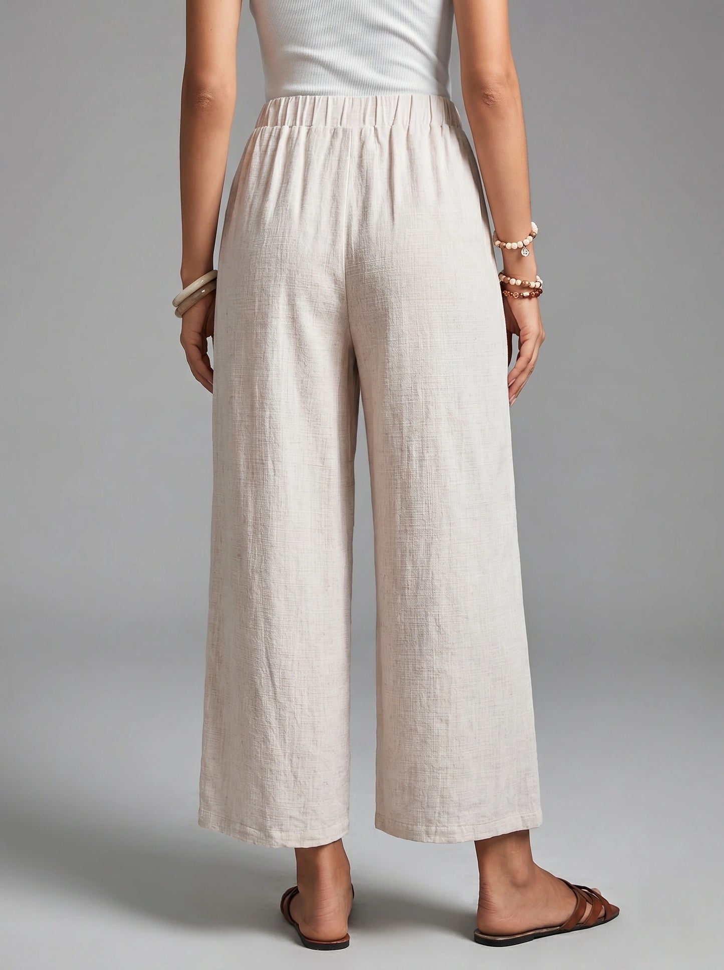 Close up view of the Womens Effortless Spring Trousers showing the high waisted design, button details, and soft fabric texture against a neutral background.