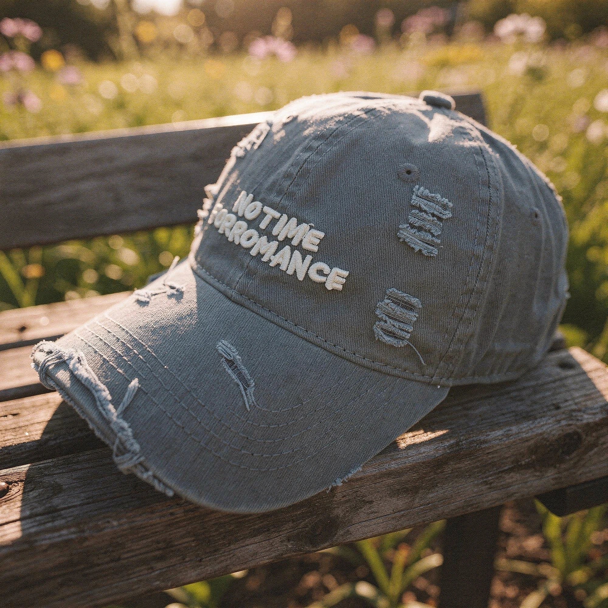 Light gray distressed baseball cap with a relaxed fit, featuring a curved brim and adjustable strap at the , view