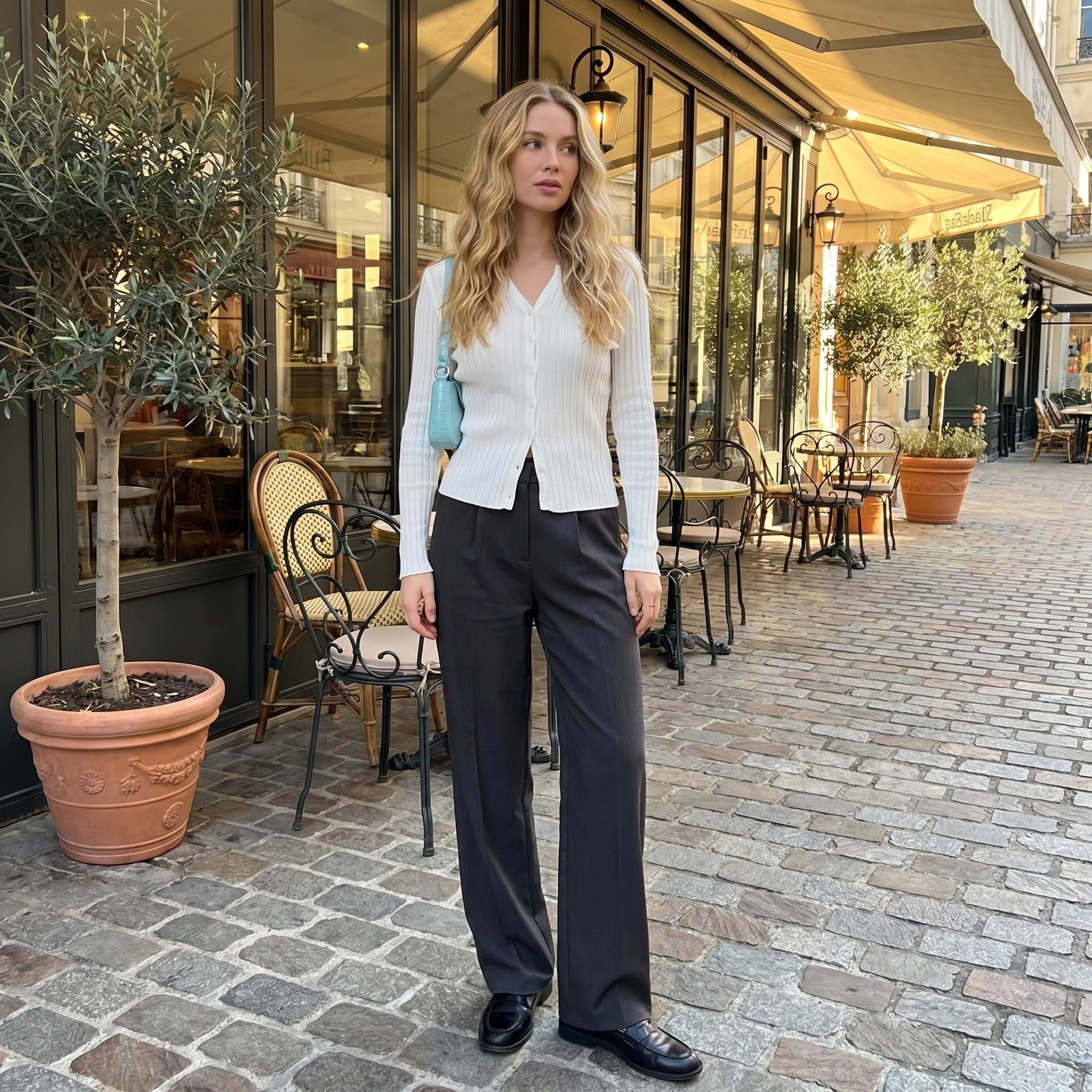 A model showcases a women's knitted sweater in Asian One size hue, styled with high waisted trousers against a neutral background.