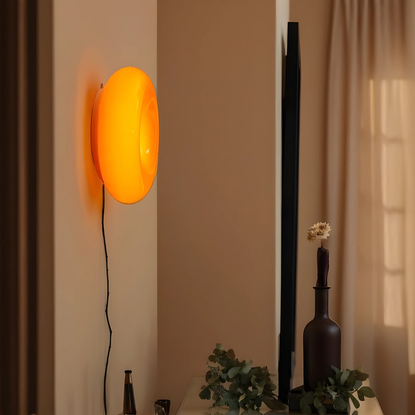 View of a sleek modern glass donut table lamp with adjustable lighting, showcasing a clear glass body and metallic accents