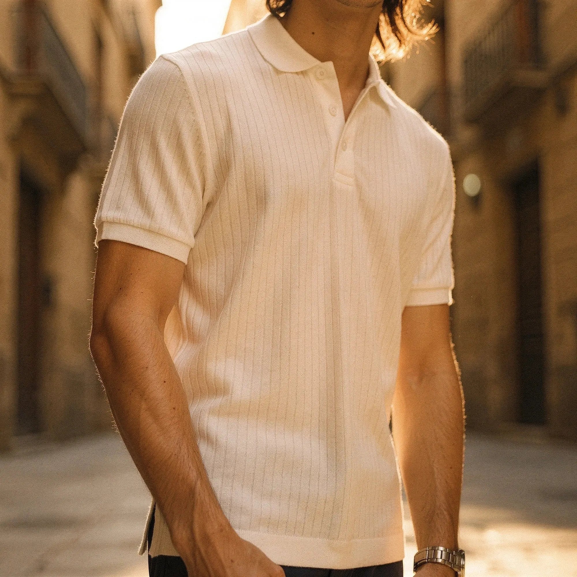 View of a slim fit short sleeve polo t shirt in light blue, made of breathable cotton, featuring a classic collar and subtle stitching