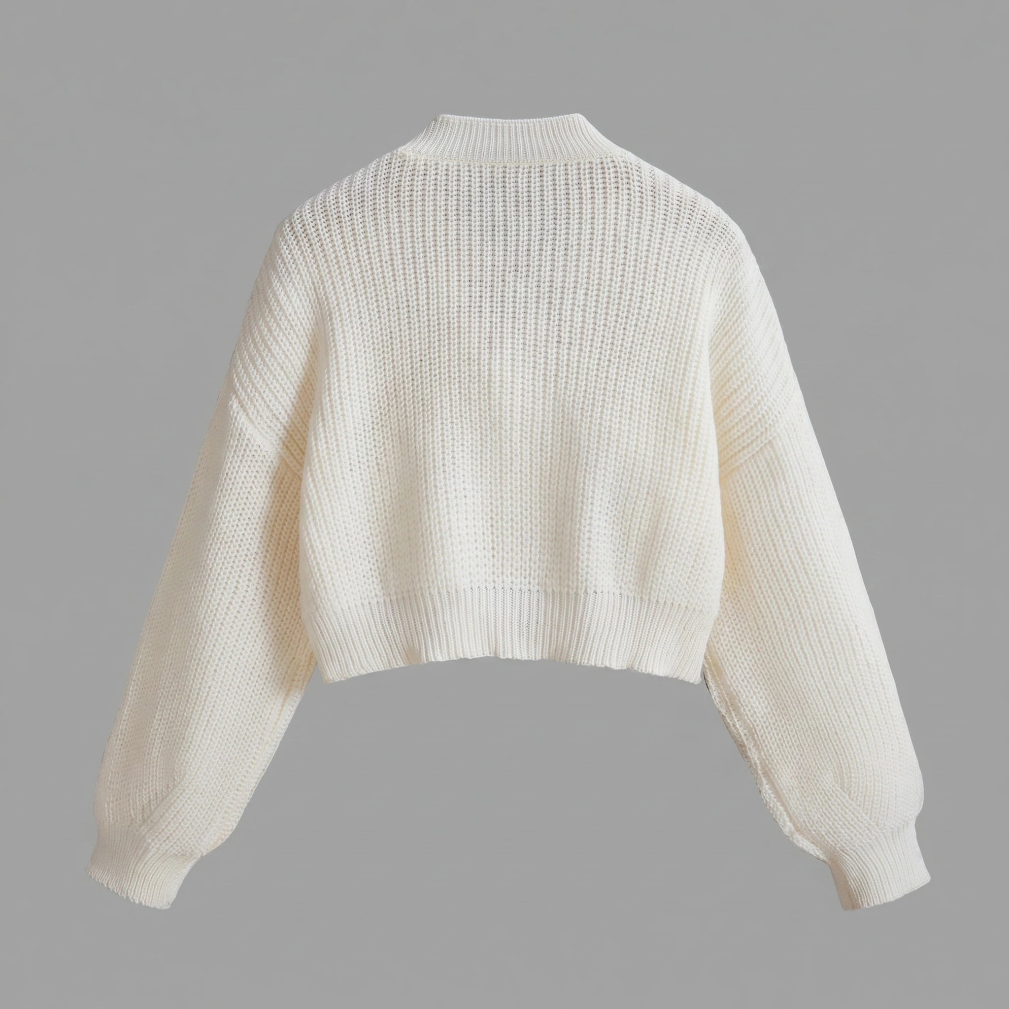 Close up view of the Womens Whimsical Cozy Spring Cardigan showing its soft fabric texture and intricate stitching details against a neutral background.