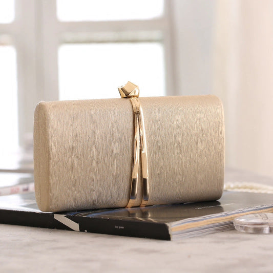 Elegant clutch bag in a soft beige fabric, featuring sleek design and subtle clasp closure, front view — 2 — view 2