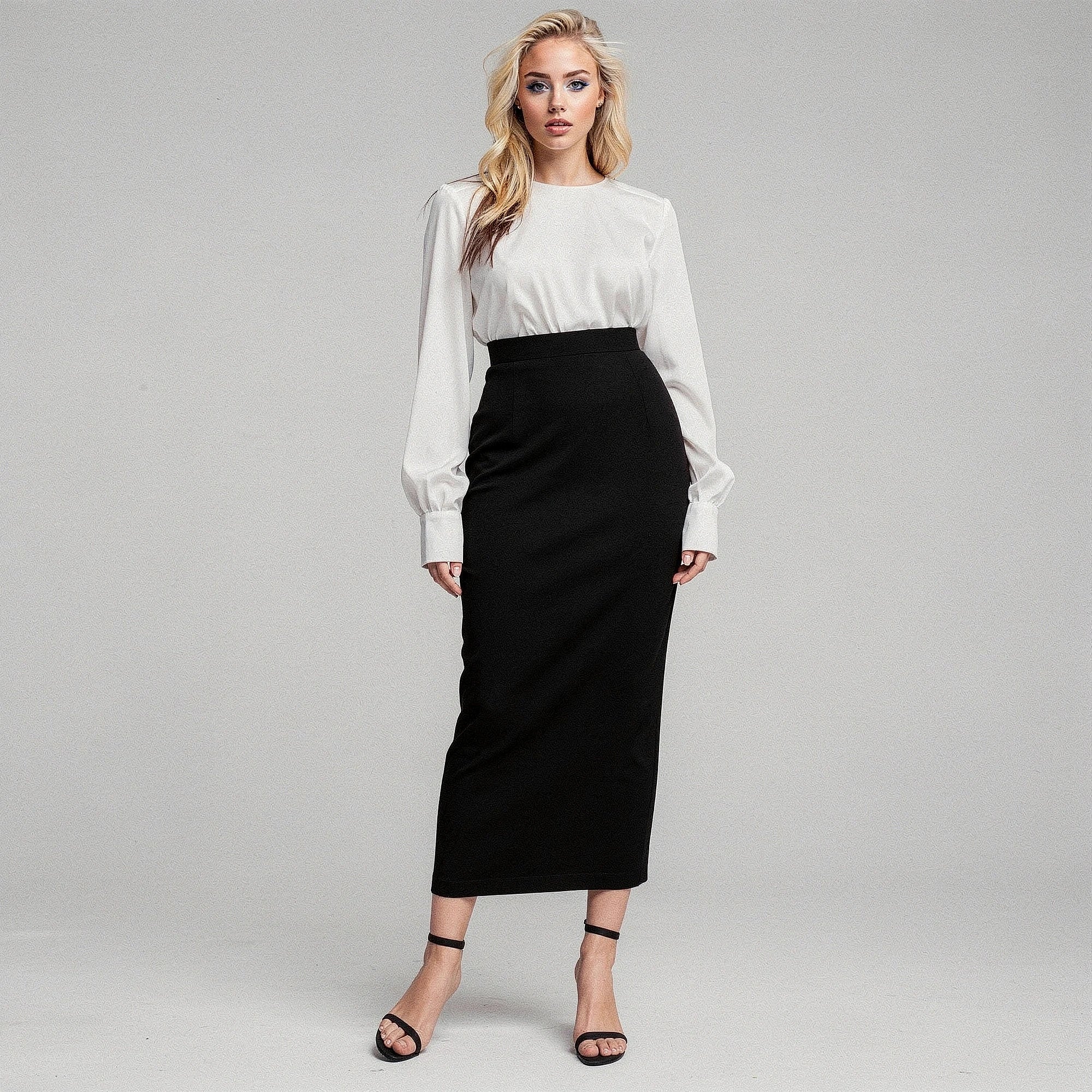 View of a women's elegant slim midi skirt in soft fabric, featuring a fitted silhouette and a classic solid color