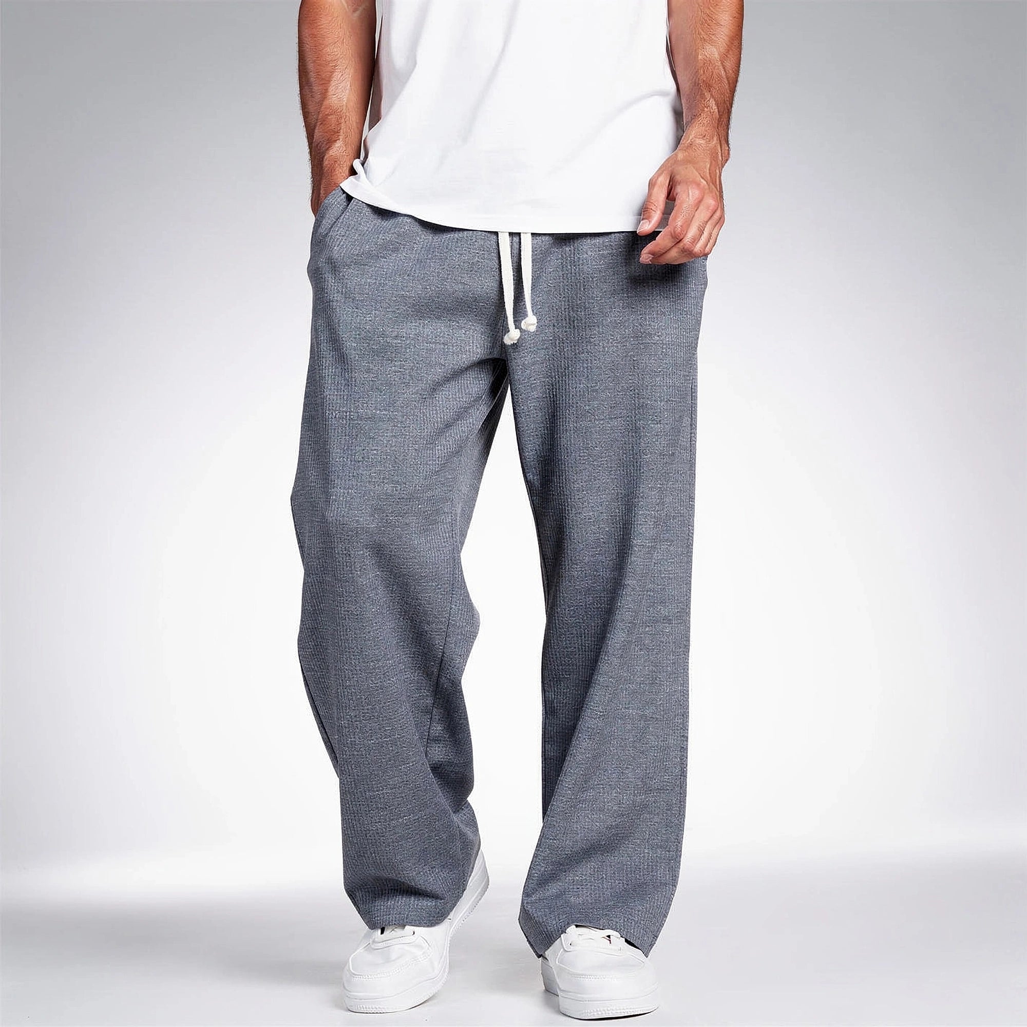 Light gray relaxed fit drawstring pants made of soft fabric, featuring pockets and a comfortable waistband, view