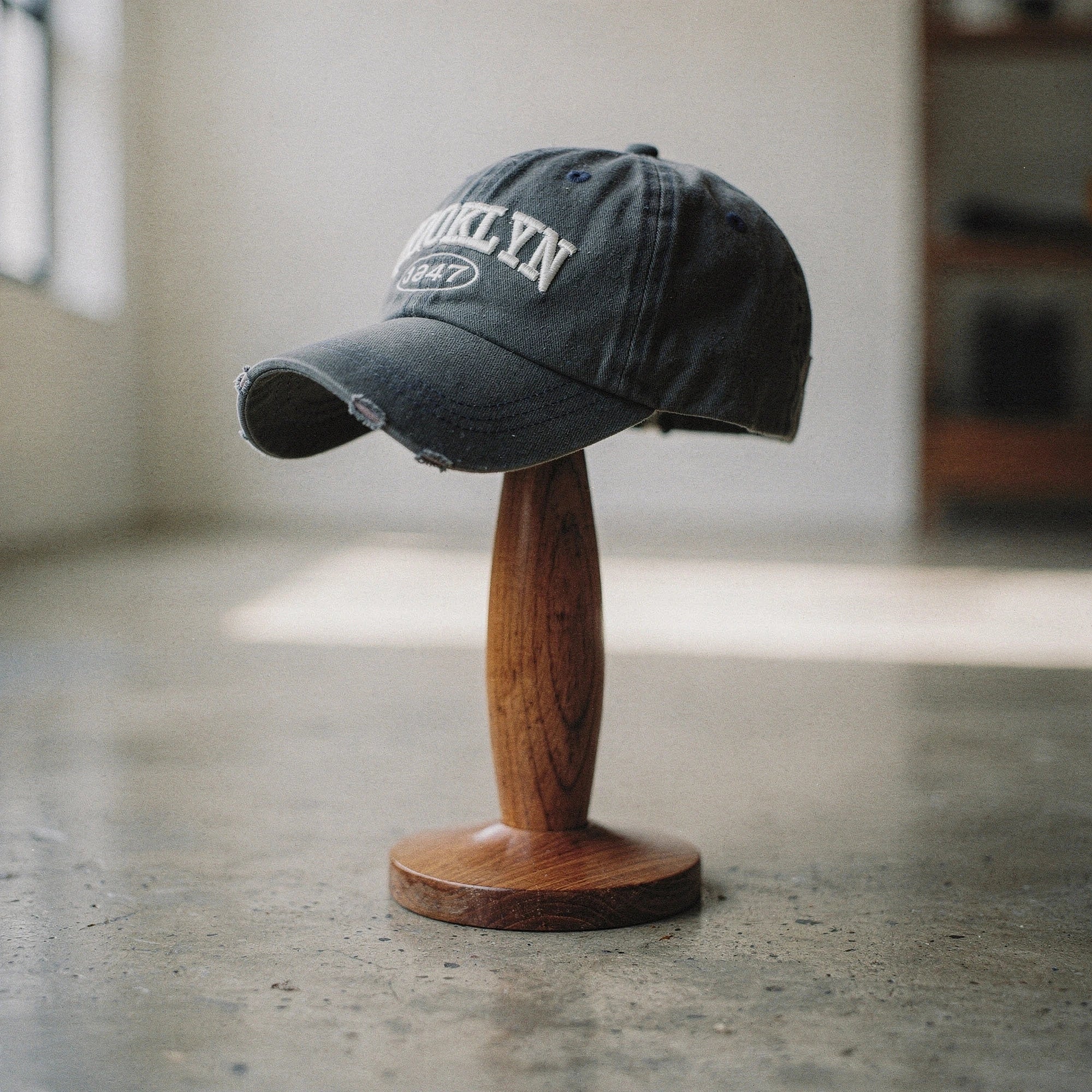 View of a khaki green embroidered cap featuring a casual chic design and adjustable strap at the