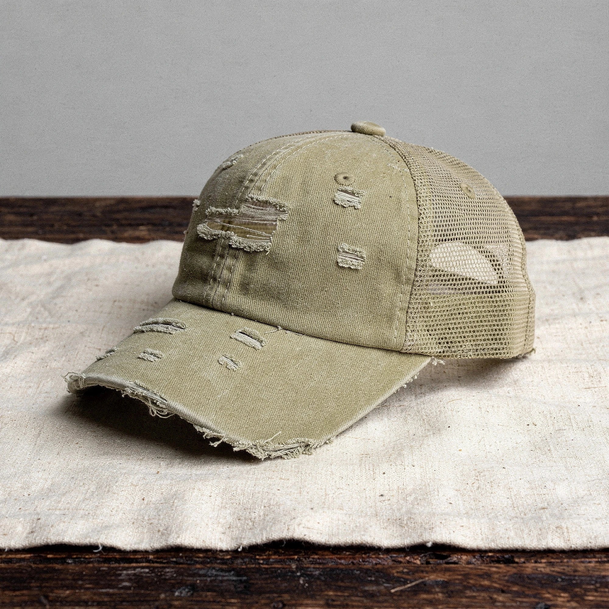 Light pink summer baseball cap made of breathable fabric, featuring a curved brim and adjustable strap, detailed view