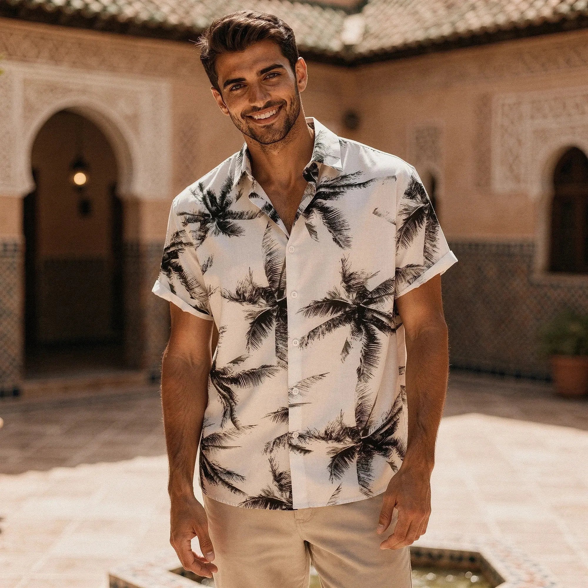 View of a slim fit short sleeve Hawaiian shirt featuring a vibrant floral pattern in shades of blue and green