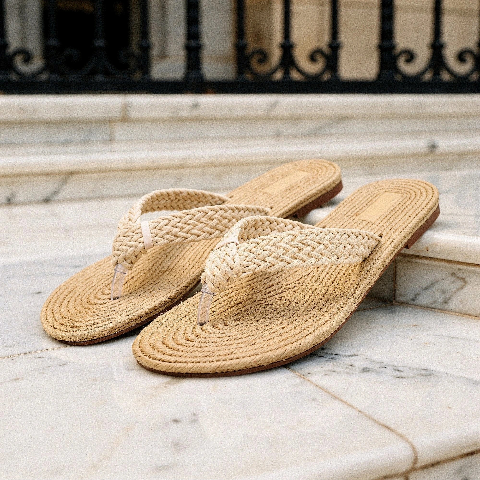 View of relaxed textured imitation hemp flip flops in natural beige color, showcasing the woven strap and cushioned sole