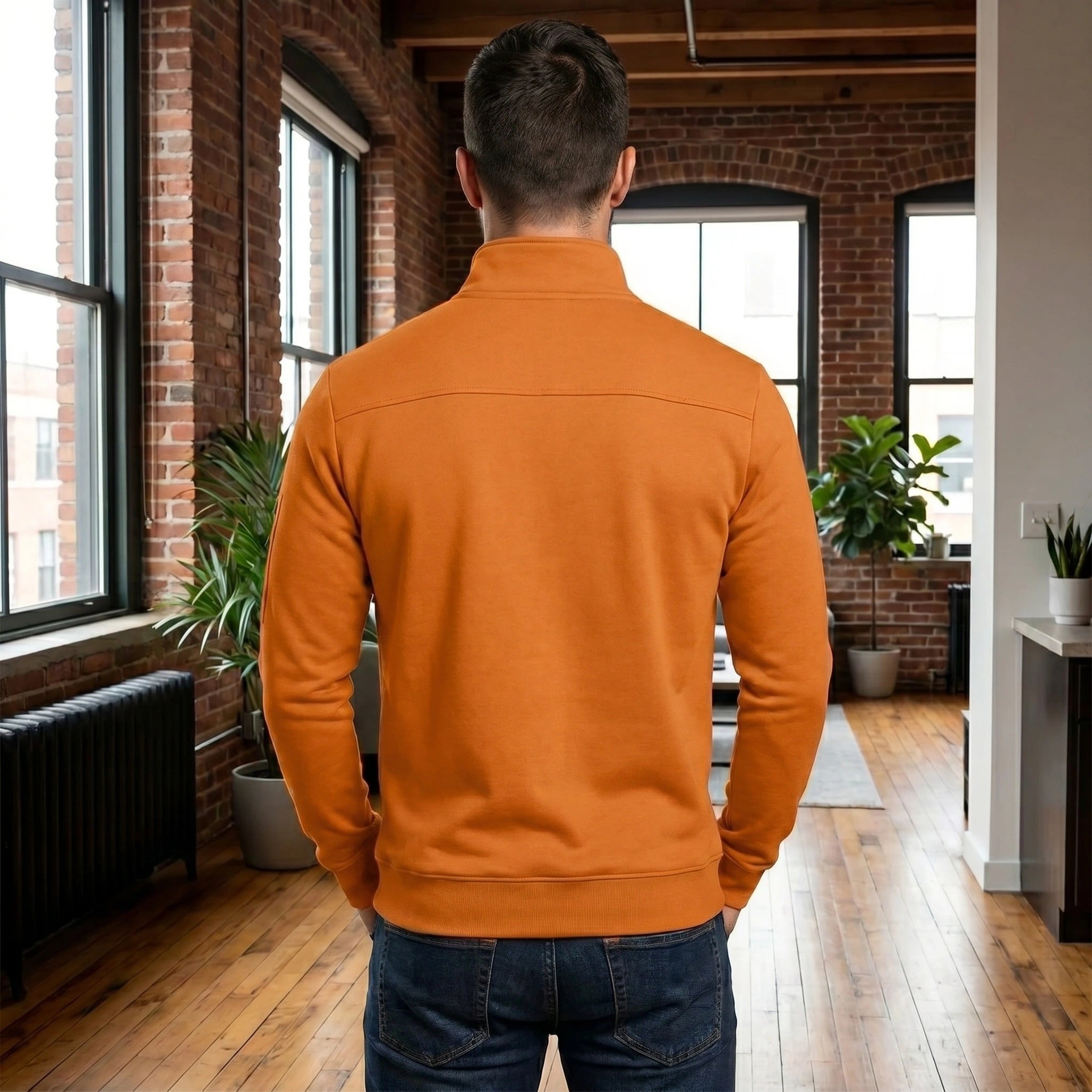 A model showcases the men's quarter zip sweater in a rich navy color, paired with casual chinos against a minimalist urban backdrop.