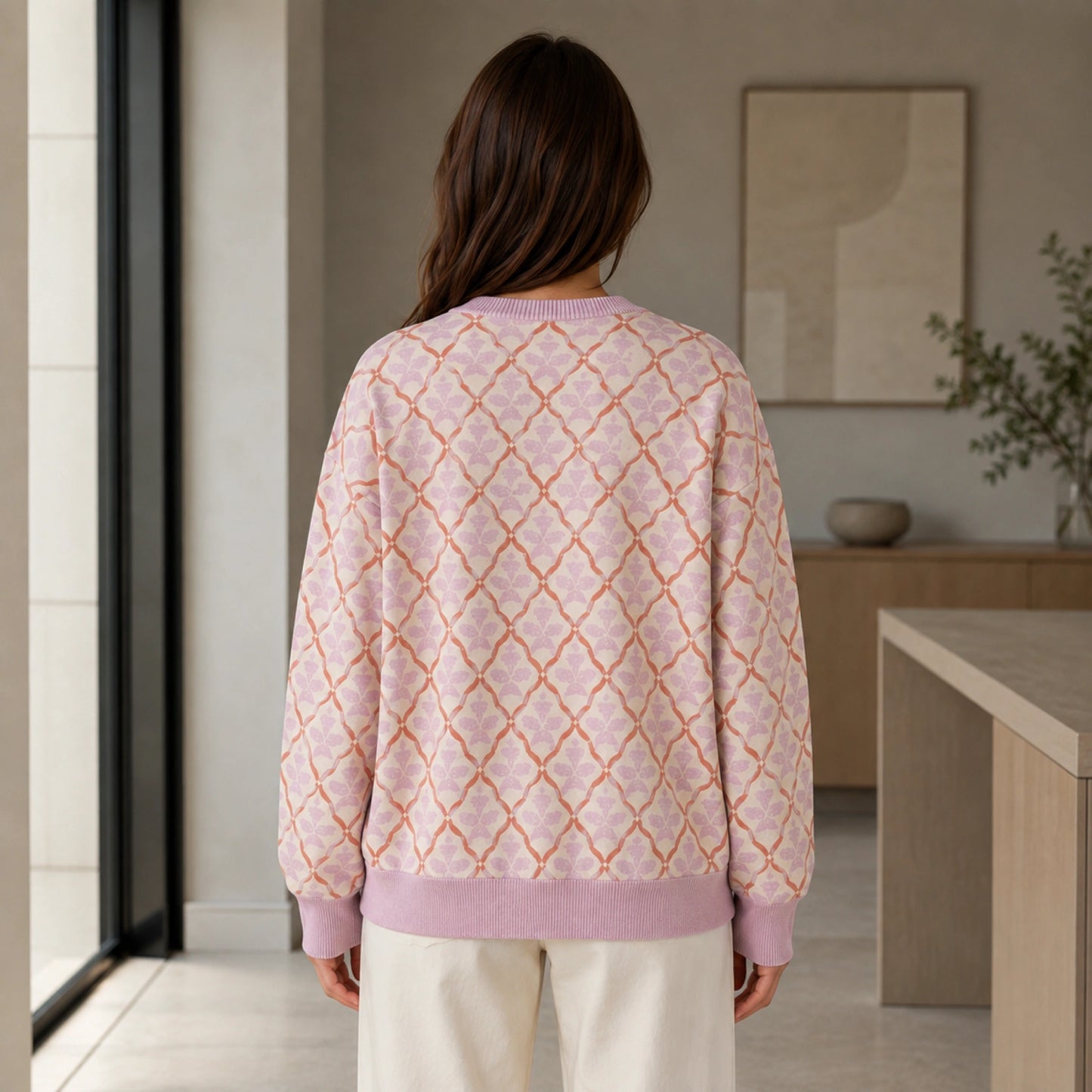 Woman wearing pink lattice jacquard letterman sweater, true back view — view 7