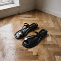 View of women's casual summer slides in soft beige with a textured upper and cushioned footbed