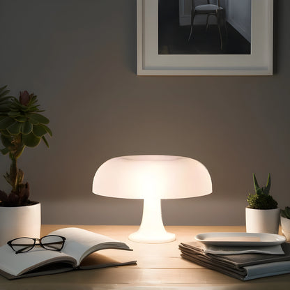 View of a contemporary sculpted acrylic mushroom table lamp featuring a translucent white shade and a sleek, modern base