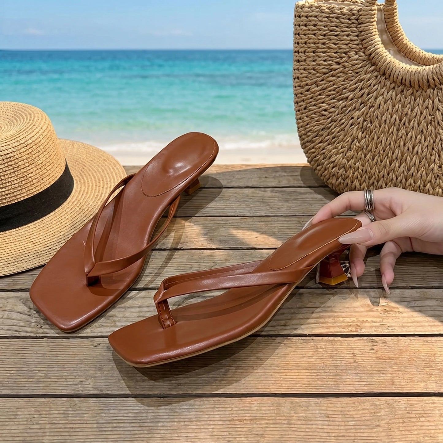 Close up view of the and comfortable fabric of women's summer slides, showing intricate stitching details against a soft, neutral background.