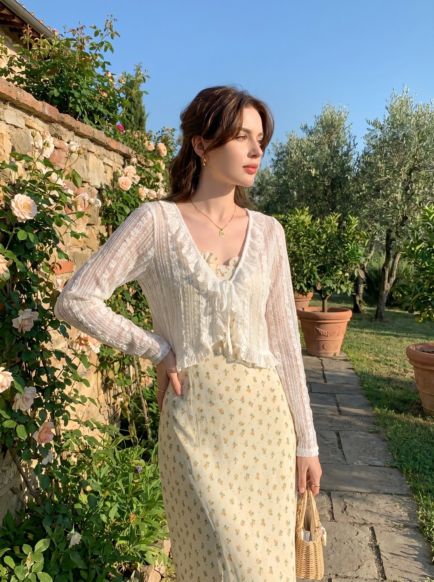 Close up view of the Womens Delicate Ruffled Summer Blouse showing intricate stitching and soft fabric texture, showing its playful ruffled details against a neutral background.