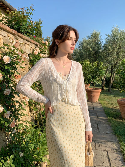 Close up view of the Womens Delicate Ruffled Summer Blouse showing intricate stitching and soft fabric texture, showing its playful ruffled details against a neutral background.
